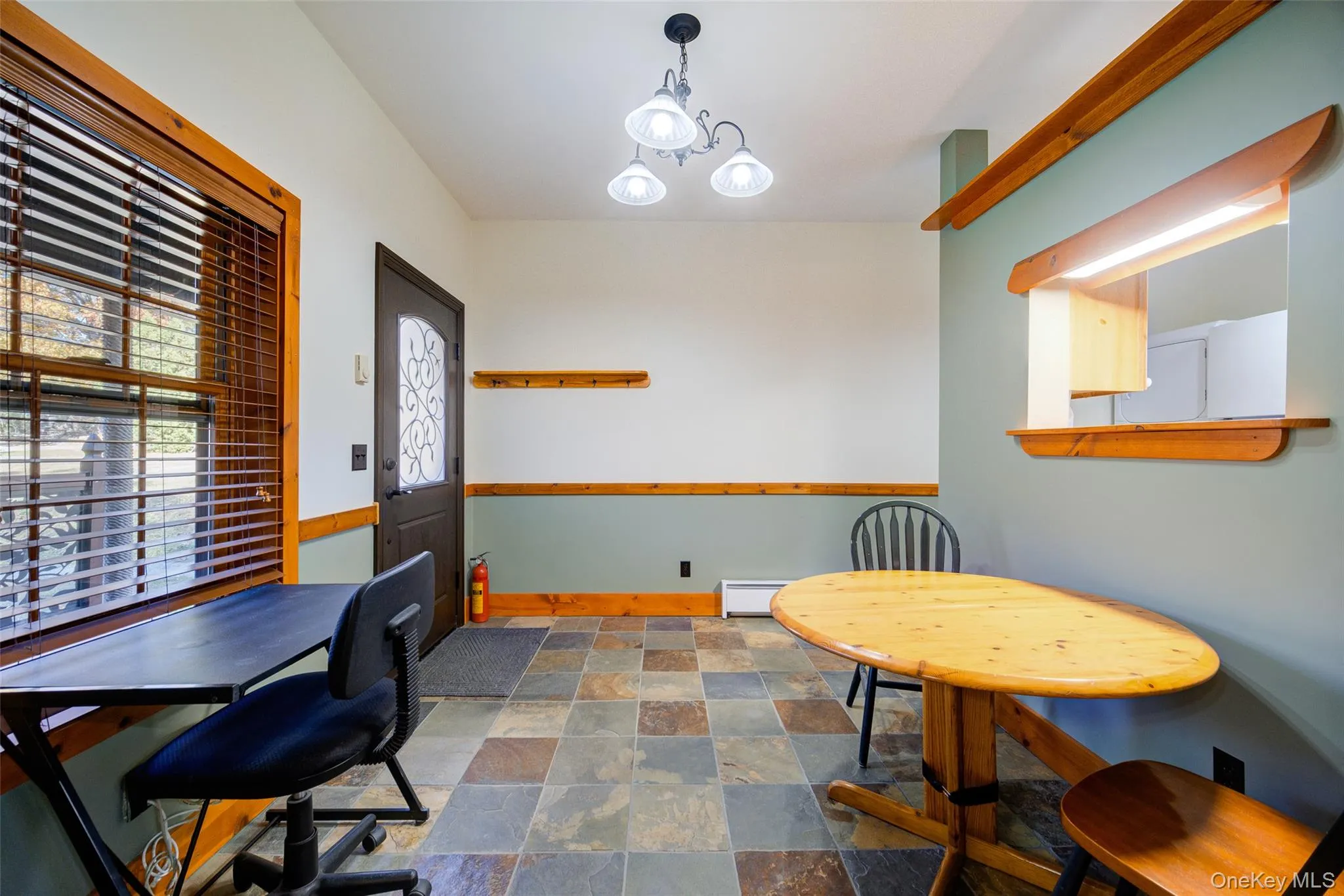 Dining area with baseboard heating and an inviting chandelier Dining area with baseboard heating and an inviting chandelier
