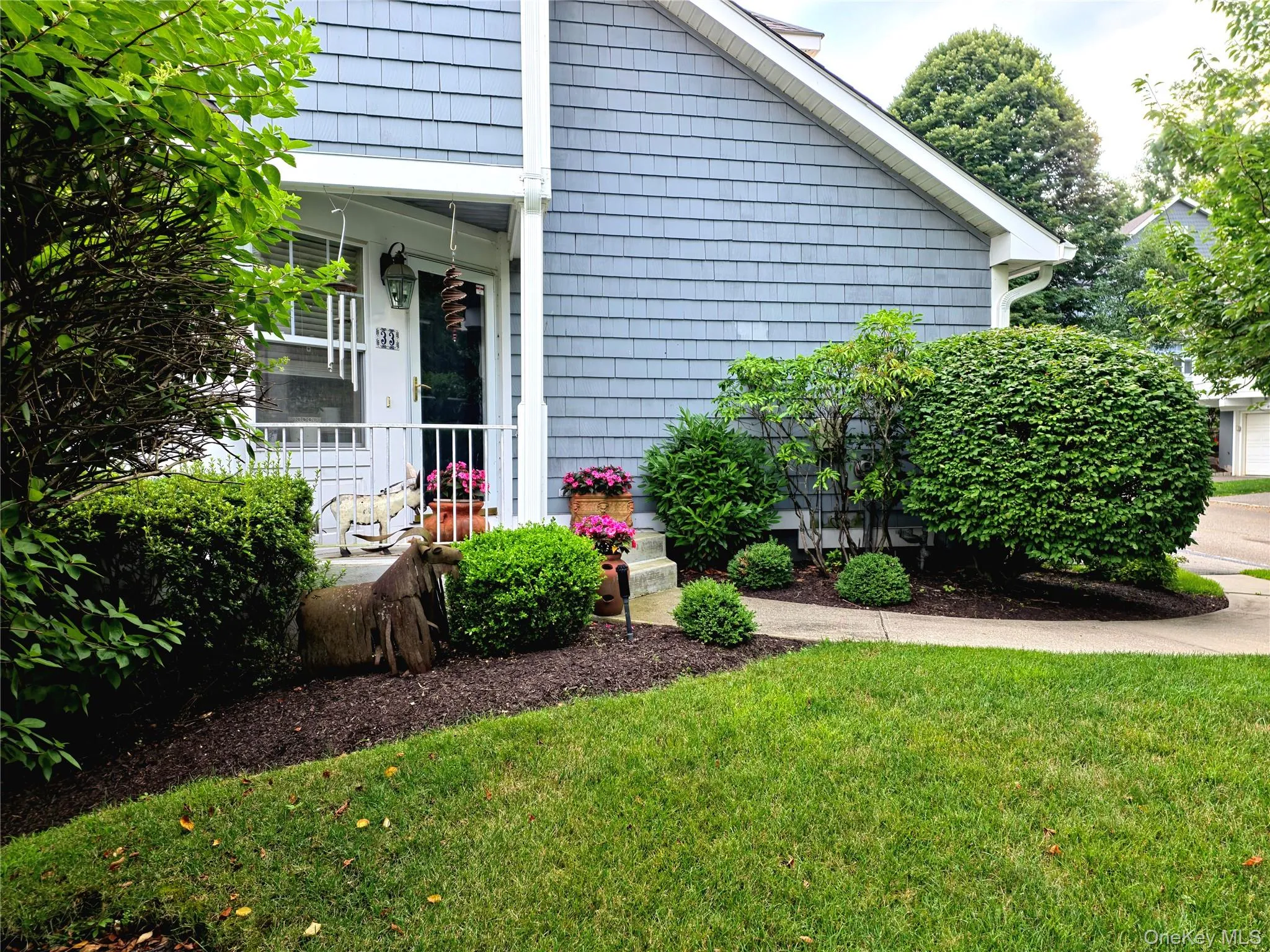 Front door with covered porch and professional landscaping Front door with covered porch and professional landscaping