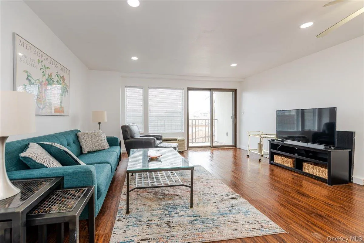 Living area featuring wood finished floors and recessed lighting Living area featuring wood finished floors and recessed lighting
