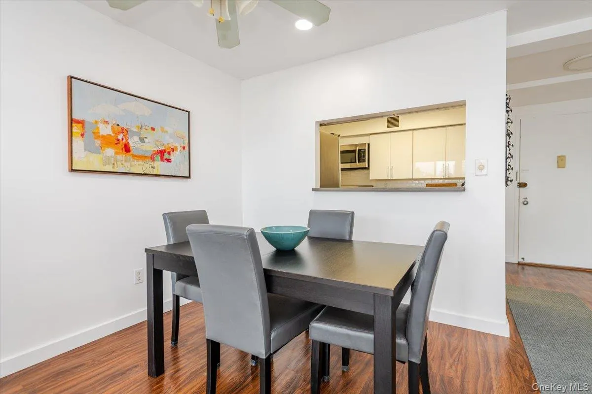 Dining space featuring a ceiling fan and wood finished floors Dining space featuring a ceiling fan and wood finished floors