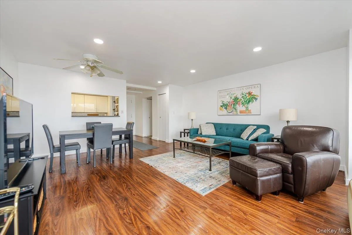 Living room featuring wood finished floors, a ceiling fan, and recessed lighting Living room featuring wood finished floors, a ceiling fan, and recessed lighting