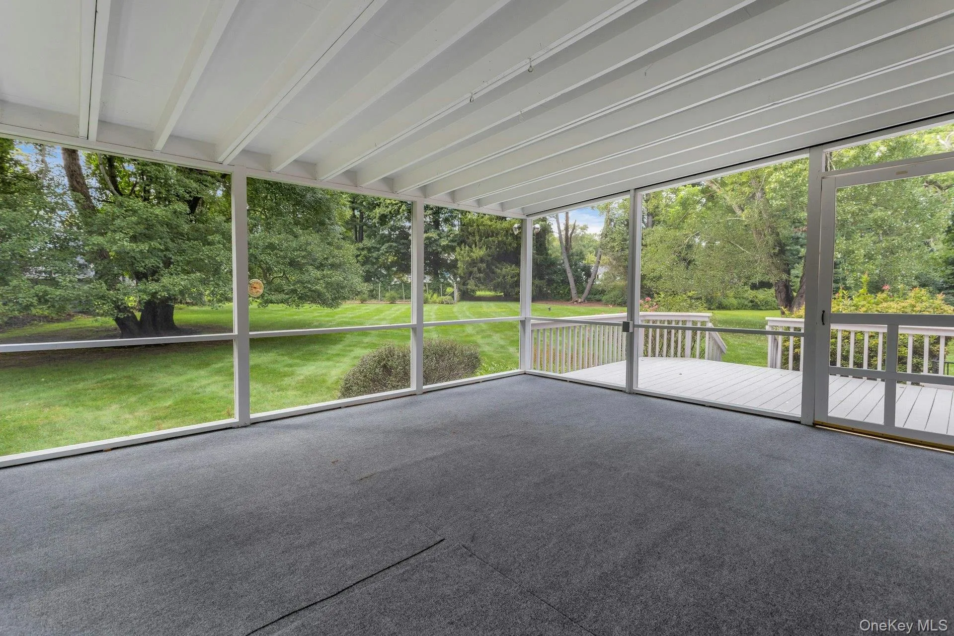 Screened porch leading to wood deck. Screened porch leading to wood deck.