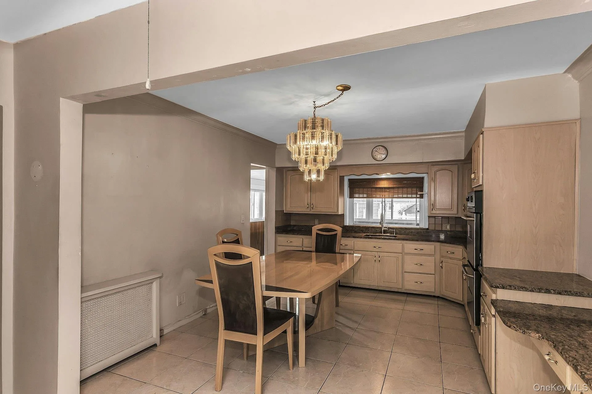 Kitchen featuring light wood-finish cabinetry, granite countertops, tile flooring, and a built-in double oven Kitchen featuring light wood-finish cabinetry, granite countertops, tile flooring, and a built-in double oven