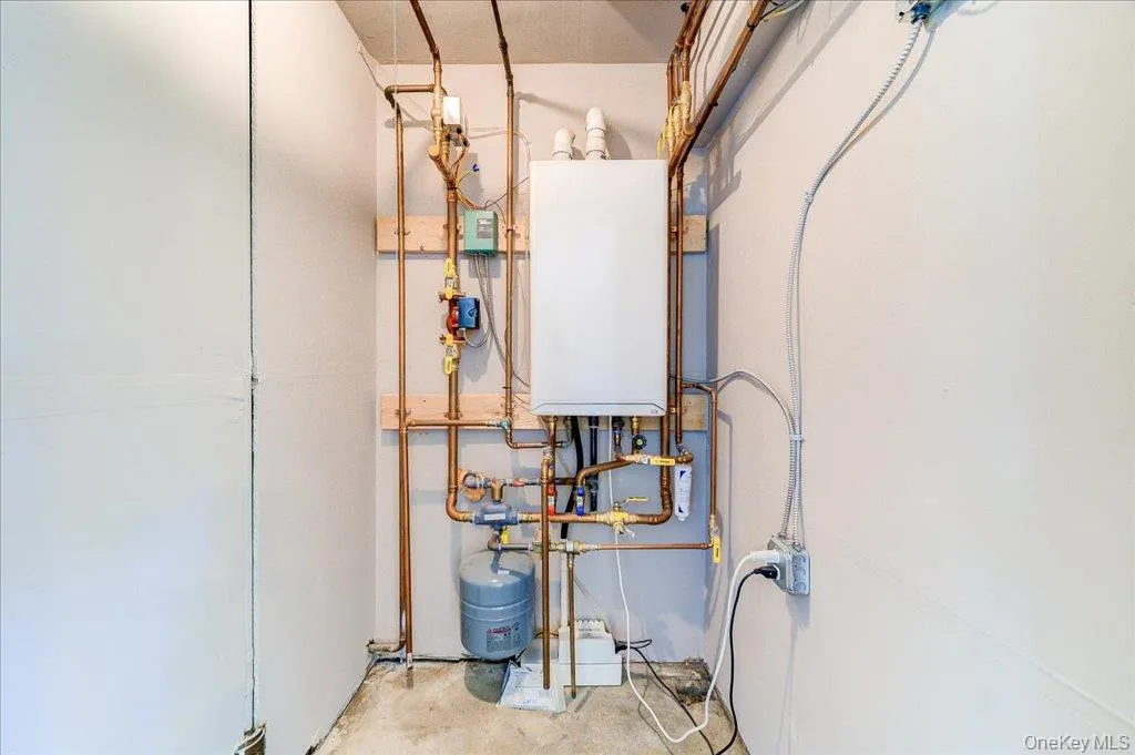 Wall-mounted water heater with copper piping and an expansion tank Wall-mounted water heater with copper piping and an expansion tank