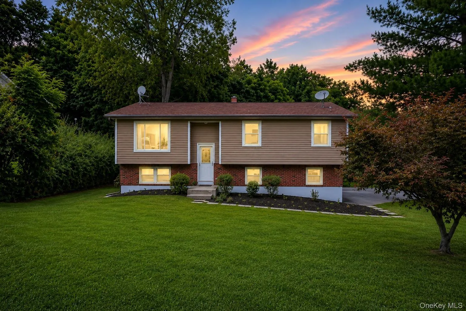 Split-level residence featuring a brick and siding exterior Split-level residence featuring a brick and siding exterior