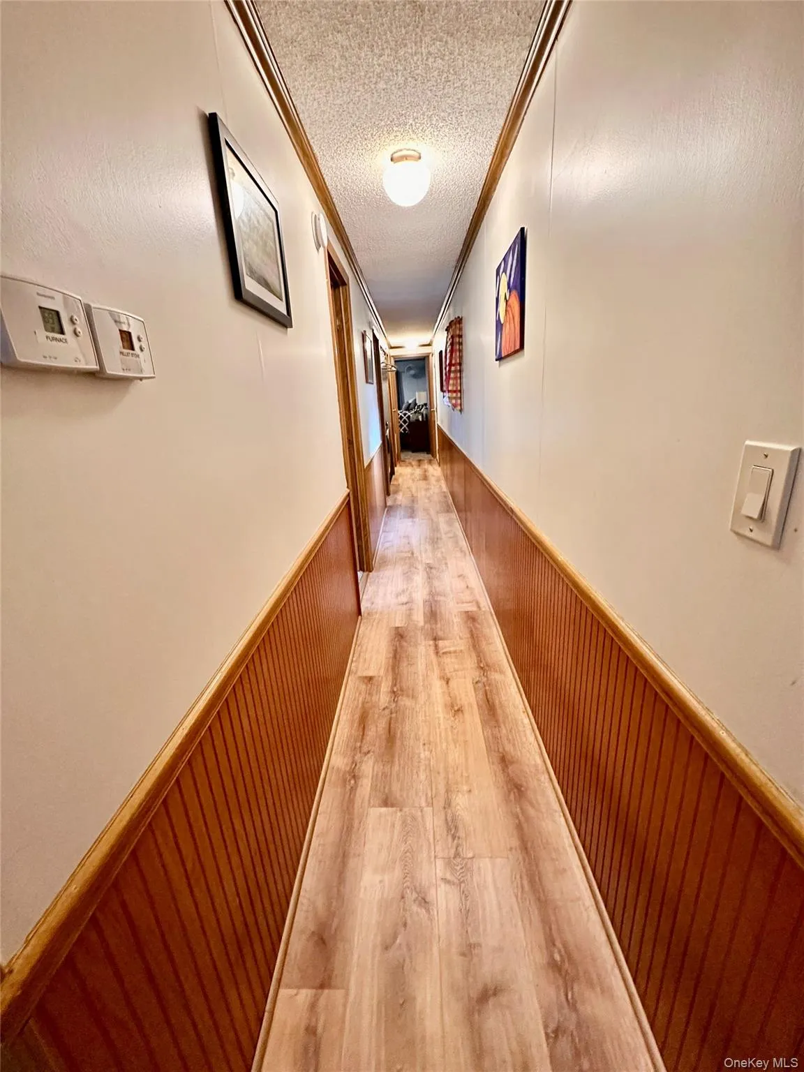 Wood-finish flooring with beadboard wainscoting and coordinating wood trim. Wood-finish flooring with beadboard wainscoting and coordinating wood trim.