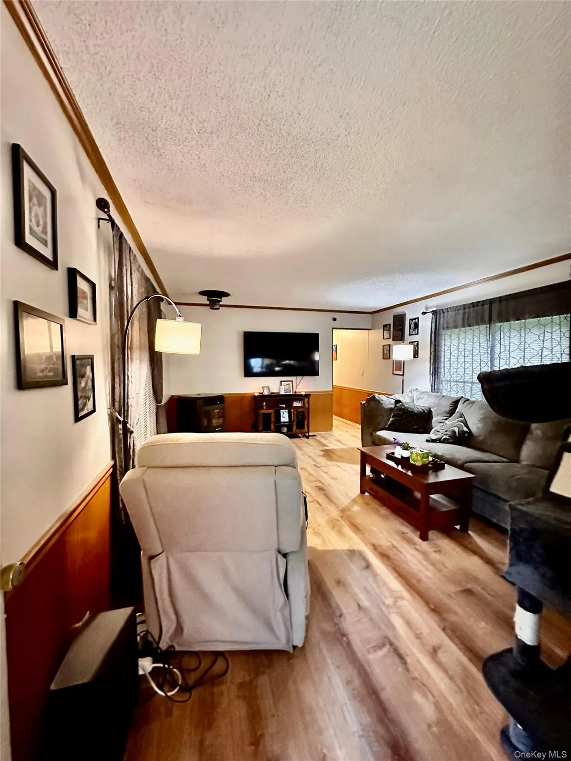 Wood-finish flooring throughout, featuring a chair rail accent, and ceiling-mounted light fixture. Wood-finish flooring throughout, featuring a chair rail accent, and ceiling-mounted light fixture.