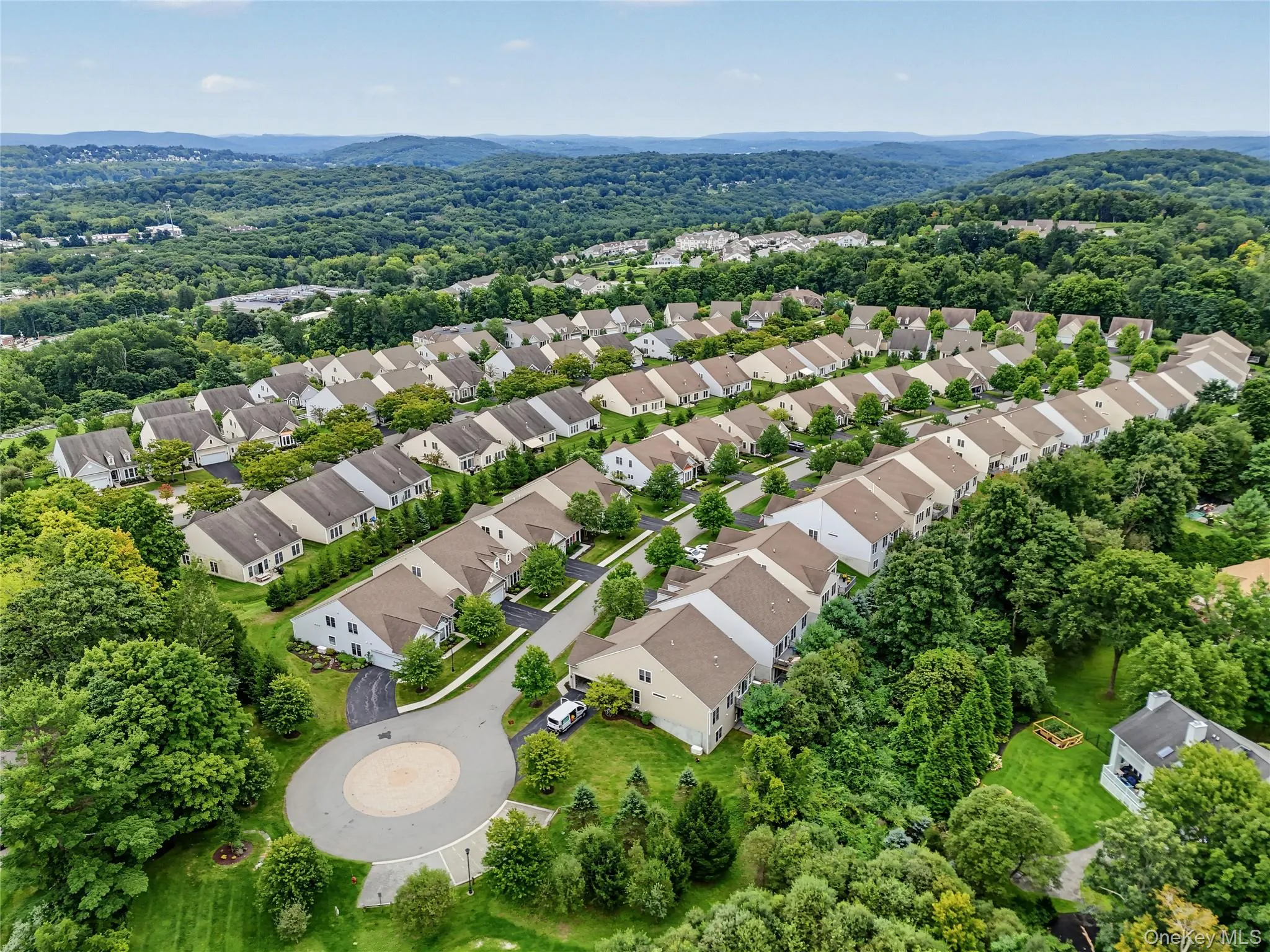 Residential development featuring multiple single-family homes, mature trees, and paved roadways Residential development featuring multiple single-family homes, mature trees, and paved roadways