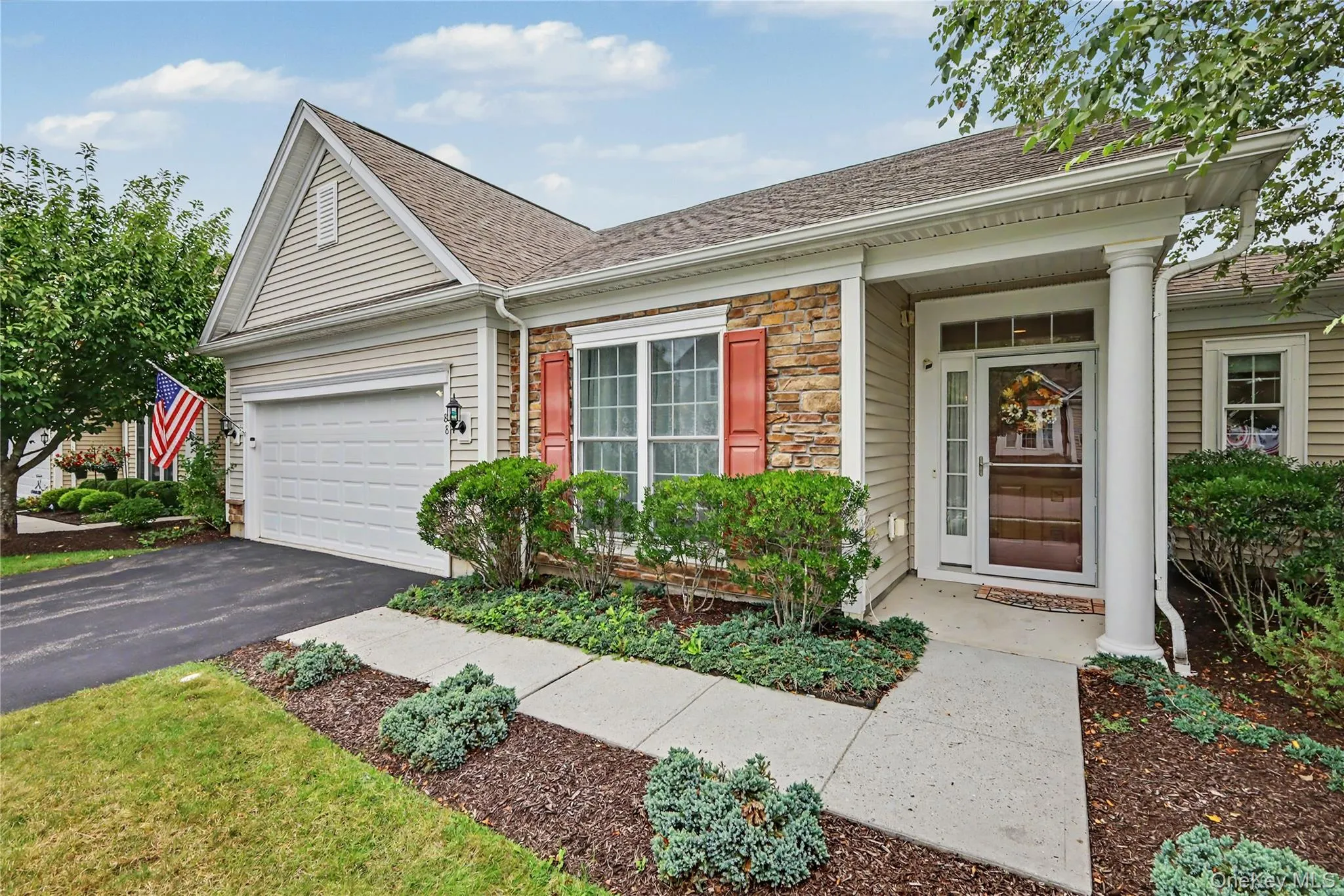 Stone facade accents, attached garage, covered entryway, detailed front door, and mature landscaping Stone facade accents, attached garage, covered entryway, detailed front door, and mature landscaping