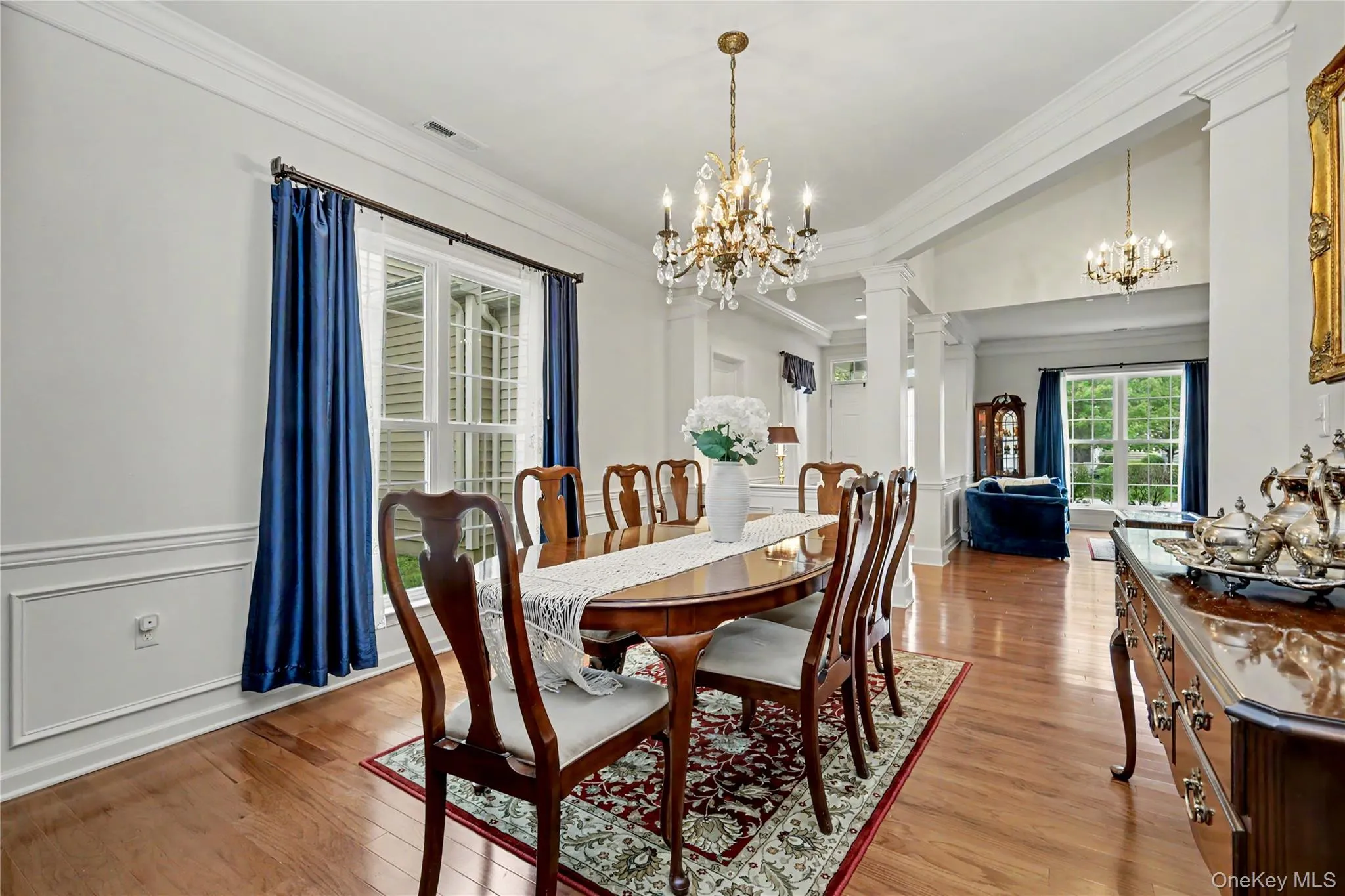 Hardwood flooring, decorative wall molding, and a crystal chandelier Hardwood flooring, decorative wall molding, and a crystal chandelier