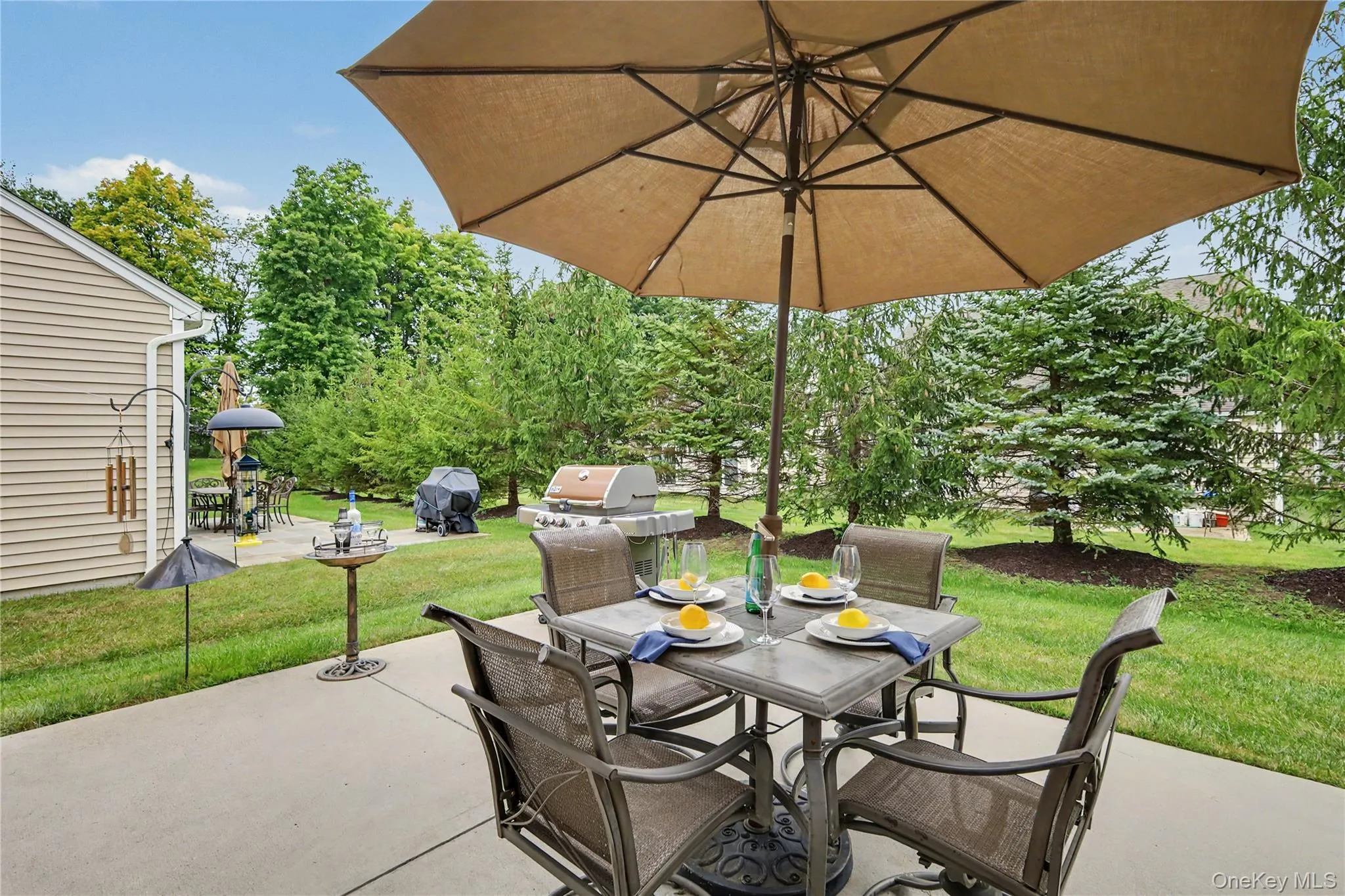 Concrete patio area featuring a dining space Concrete patio area featuring a dining space