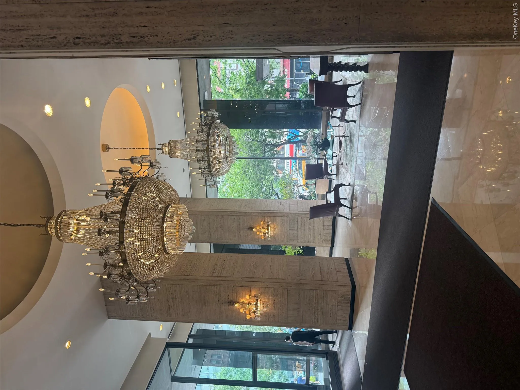 Polished tile flooring, multiple crystal chandeliers, recessed ceiling lighting, and large pane windows Polished tile flooring, multiple crystal chandeliers, recessed ceiling lighting, and large pane windows