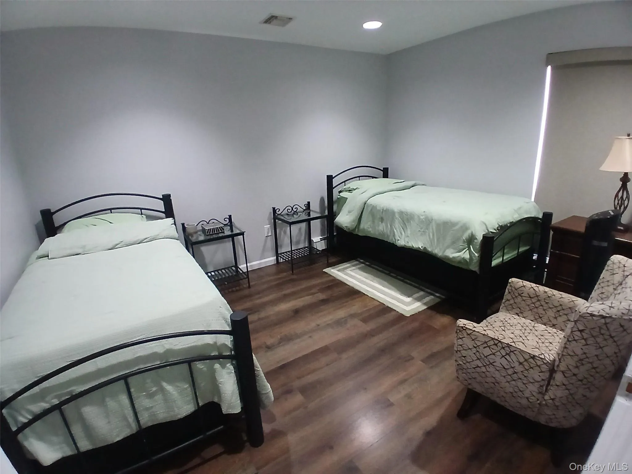 Recessed lighting, wood-finish flooring, and a roller shade window treatment Recessed lighting, wood-finish flooring, and a roller shade window treatment