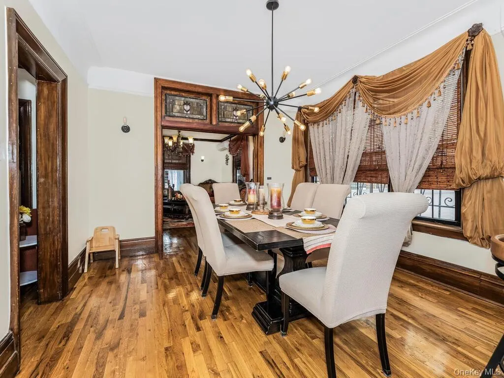 Dining room featuring hardwood / wood-style flooring and a chandelier Dining room featuring hardwood / wood-style flooring and a chandelier