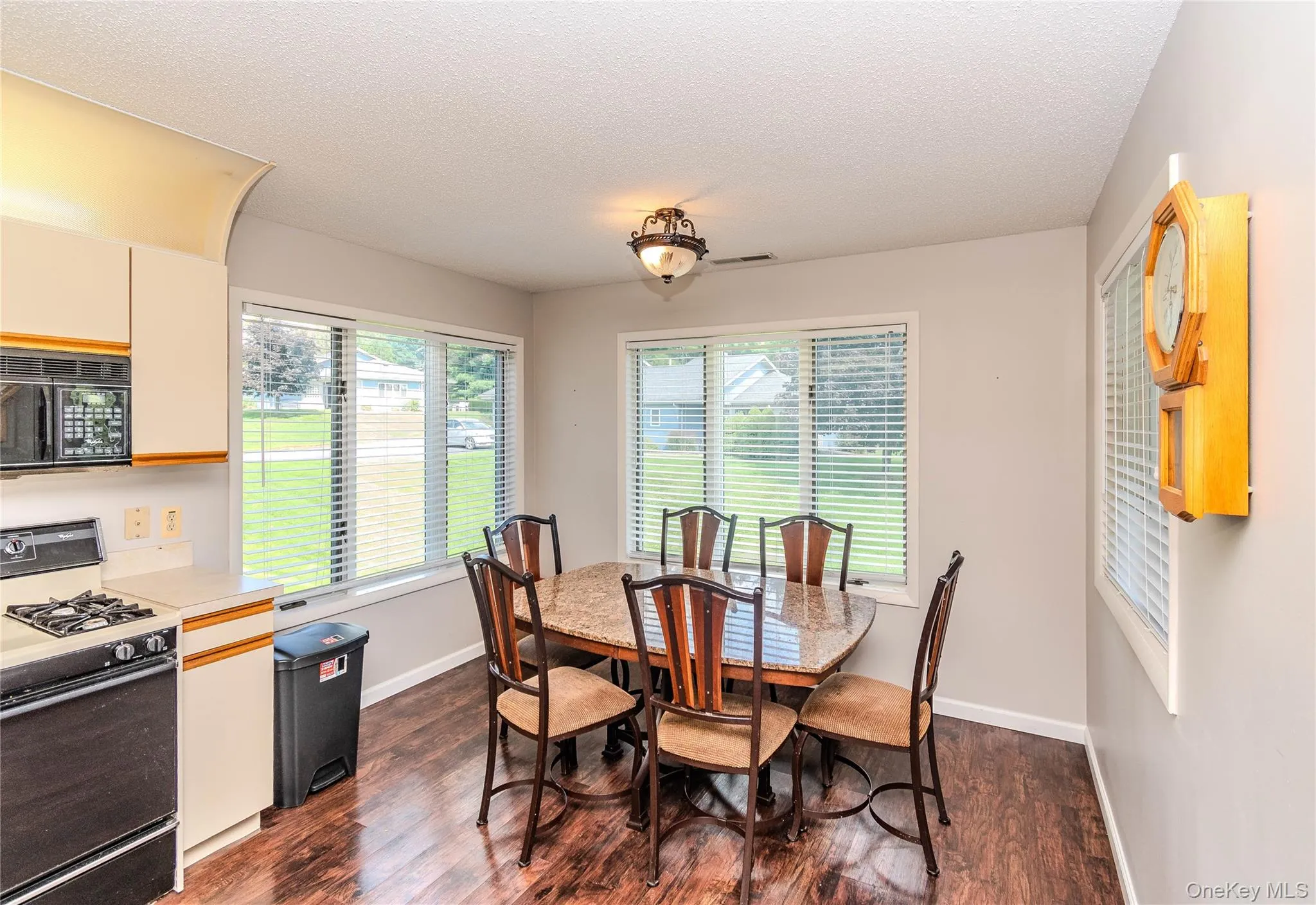 Wood-finish flooring, recessed lighting, and expansive windows Wood-finish flooring, recessed lighting, and expansive windows