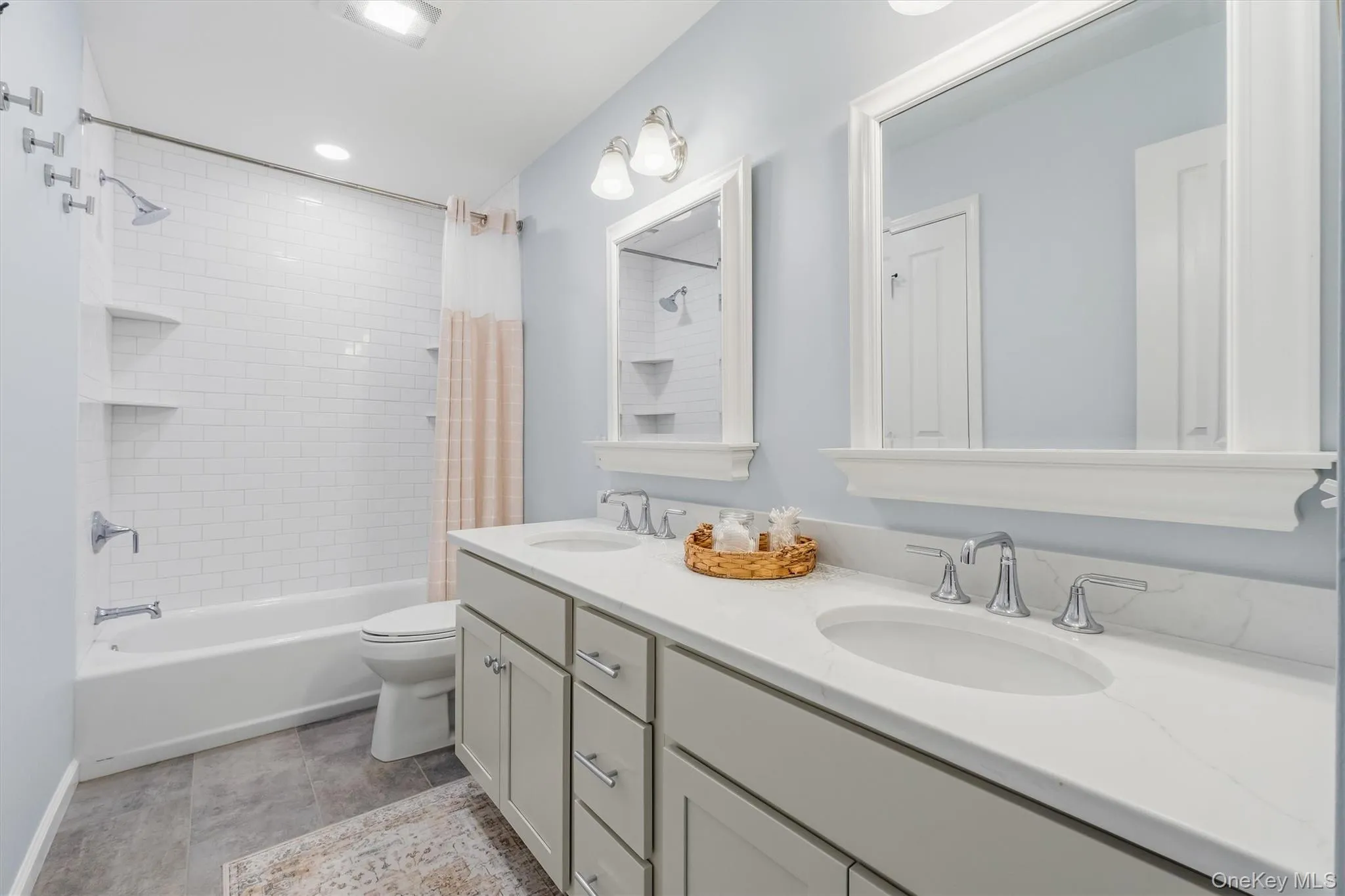 Just completed, this beautifully reimagined full hall bathroom offers a luxurious retreat for the home’s three additional bedrooms. Thoughtfully curated with sophisticated finishes, the space showcases a new five-foot Americast tub surrounded by custom subway tile, oversized stone-tile flooring, and an elegant double vanity. A new toilet, stylish mirrors, and updated lighting complete the refined design, creating a fresh and inviting bathroom that blends timeless elegance with modern comfort. Just completed, this beautifully reimagined full hall bathroom offers a luxurious retreat for the home’s three additional bedrooms. Thoughtfully curated with sophisticated finishes, the space showcases a new five-foot Americast tub surrounded by custom subway tile, oversized stone-tile flooring, and an elegant double vanity. A new toilet, stylish mirrors, and updated lighting complete the refined design, creating a fresh and inviting bathroom that blends timeless elegance with modern comfort.