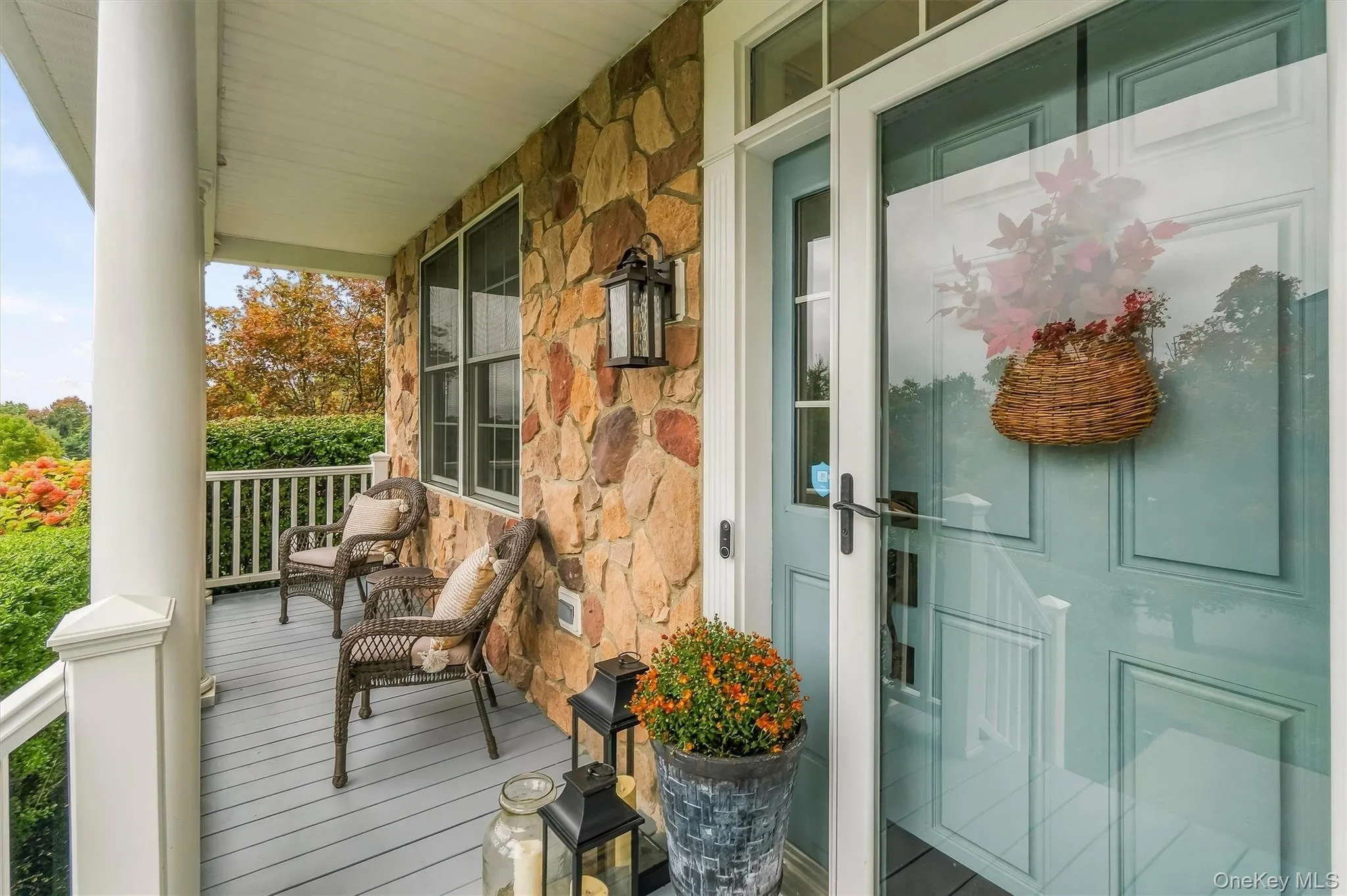 The cozy rocking-chair porch, finished with Trex decking and maintenance-free railings, offers an inviting place to relax and enjoy the beautiful surroundings. A stone entryway creates a welcoming transition indoors, while the meticulously landscaped lot, framed by mature trees and lush plantings, provides a peaceful sense of privacy and serenity. Whether savoring a quiet morning or unwinding in the evening, this welcoming porch is the perfect place to take in the neighborhood views and enjoy the neighborhood’s mountainous views. The cozy rocking-chair porch, finished with Trex decking and maintenance-free railings, offers an inviting place to relax and enjoy the beautiful surroundings. A stone entryway creates a welcoming transition indoors, while the meticulously landscaped lot, framed by mature trees and lush plantings, provides a peaceful sense of privacy and serenity. Whether savoring a quiet morning or unwinding in the evening, this welcoming porch is the perfect place to take in the neighborhood views and enjoy the neighborhood’s mountainous views.
