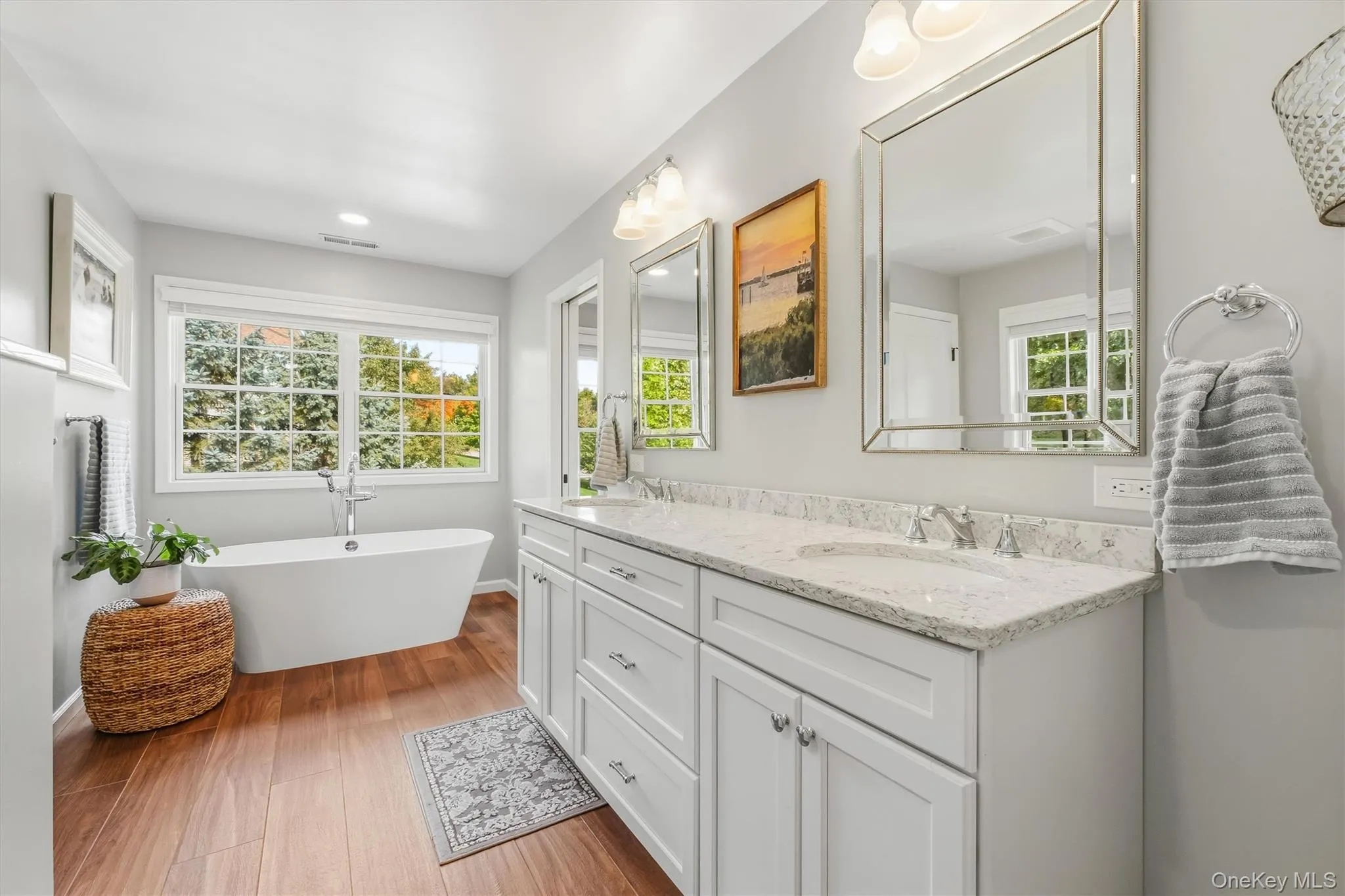 As refined as it is functional, this exquisite primary bathroom features a custom double vanity with abundant storage and beautifully coordinated quartz countertops that lend an elevated, polished finish. Upgraded fixtures add a touch of sophistication, while separate his-and-her mirrors create a clean, tailored aesthetic. Thoughtfully curated for elegance, efficiency, and everyday comfort, every detail enhances the bath’s serene, spa-inspired atmosphere. As refined as it is functional, this exquisite primary bathroom features a custom double vanity with abundant storage and beautifully coordinated quartz countertops that lend an elevated, polished finish. Upgraded fixtures add a touch of sophistication, while separate his-and-her mirrors create a clean, tailored aesthetic. Thoughtfully curated for elegance, efficiency, and everyday comfort, every detail enhances the bath’s serene, spa-inspired atmosphere.