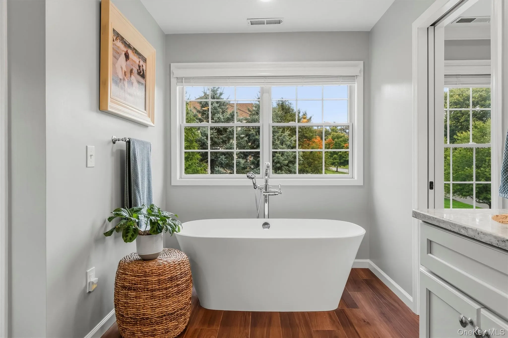 An elegant soaking tub rests beneath a pair of windows framing tranquil mountain views, creating an exquisite setting in which to unwind in complete comfort and style. A sleek floor-mounted tub faucet lends a sophisticated, sculptural accent, completing this serene spa-like focal point with a refined modern touch. An elegant soaking tub rests beneath a pair of windows framing tranquil mountain views, creating an exquisite setting in which to unwind in complete comfort and style. A sleek floor-mounted tub faucet lends a sophisticated, sculptural accent, completing this serene spa-like focal point with a refined modern touch.