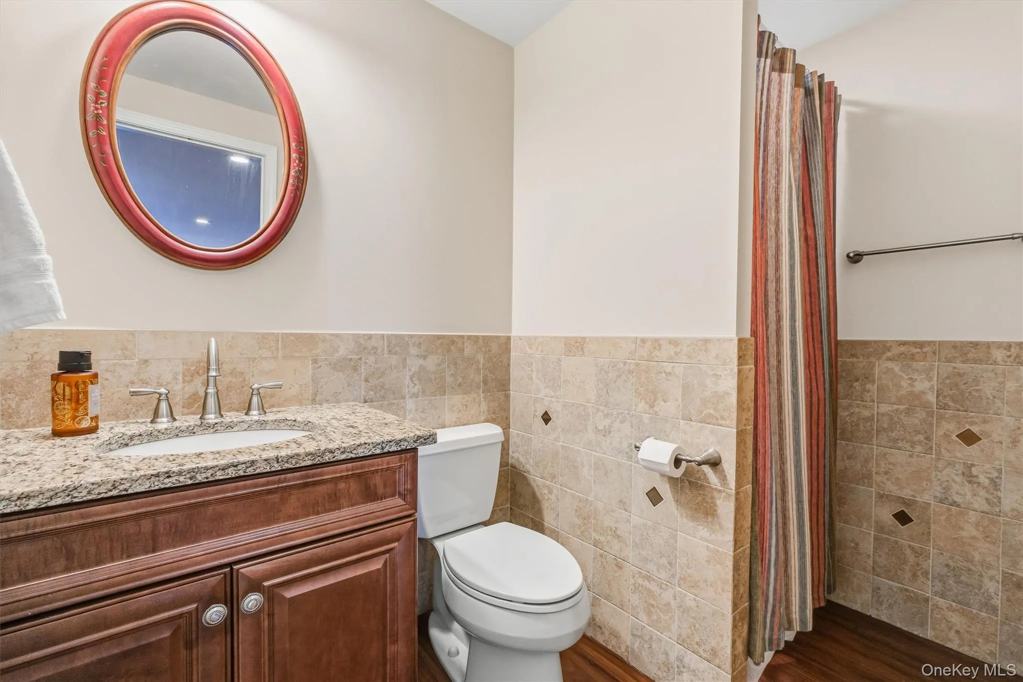 Tastefully designed to complement the home’s impressive lower level, this full bathroom blends refined style with exceptional convenience. The space features a convenient shower with a sleek surround, a custom wood vanity topped with granite, and tile detailing extending four feet around the room for an elevated, cohesive finish. Beautifully appointed and highly functional, it offers a comfortable private amenity for overnight guests, extended family, or in-law accommodations, while also providing easy access during movie nights and gatherings—without the need to go upstairs. This polished bathroom adds another layer of comfort, flexibility, and sophistication to the beautifully finished lower level. Additional storage areas house water softener & radon systems, as well as Additional storage area with additional second freezer. Tastefully designed to complement the home’s impressive lower level, this full bathroom blends refined style with exceptional convenience. The space features a convenient shower with a sleek surround, a custom wood vanity topped with granite, and tile detailing extending four feet around the room for an elevated, cohesive finish. Beautifully appointed and highly functional, it offers a comfortable private amenity for overnight guests, extended family, or in-law accommodations, while also providing easy access during movie nights and gatherings—without the need to go upstairs. This polished bathroom adds another layer of comfort, flexibility, and sophistication to the beautifully finished lower level. Additional storage areas house water softener & radon systems, as well as Additional storage area with additional second freezer.