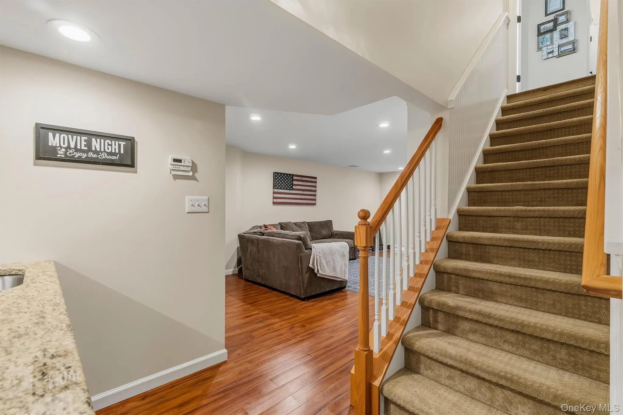 Recently completed, this impressive 1,300-square-foot lower level offers exceptional versatility, with excellent potential for an in-law or mother-daughter arrangement. Designed for both comfortable living and effortless entertaining, the space features a full bathroom, a summer kitchen, and premium luxury vinyl plank flooring complemented by fresh, modern paint for a polished, move-in-ready finish. Custom built-in shelving and cabinetry add style and functionality, creating an inviting setting for movie and game nights, casual gatherings, or extended family and guests Recently completed, this impressive 1,300-square-foot lower level offers exceptional versatility, with excellent potential for an in-law or mother-daughter arrangement. Designed for both comfortable living and effortless entertaining, the space features a full bathroom, a summer kitchen, and premium luxury vinyl plank flooring complemented by fresh, modern paint for a polished, move-in-ready finish. Custom built-in shelving and cabinetry add style and functionality, creating an inviting setting for movie and game nights, casual gatherings, or extended family and guests