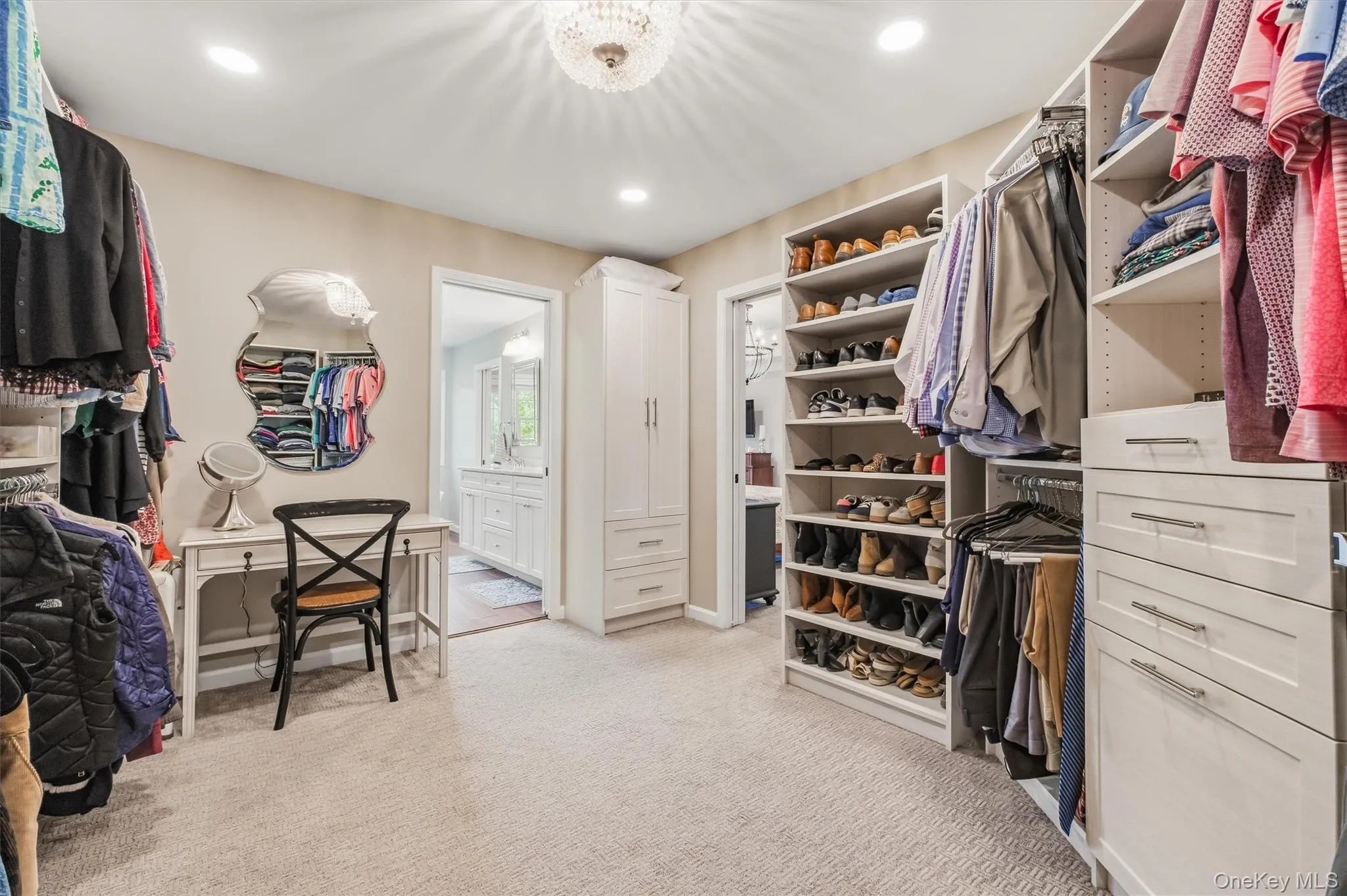 View#2This MUST-HAVE CUSTOM DRESSING ROOM is More than a walk-in closet, this beautifully designed dressing room feels like a private boutique within the primary suite. Elegant pocket doors open to reveal custom cabinetry, built-in shelving, and thoughtfully planned storage for clothing, shoes, and accessories. An elegant chandelier adds a refined finishing touch, creating a bright and polished space where getting dressed feels effortless and enjoyable. Stylish, organized, and highly functional, this custom dressing room brings everyday luxury to your daily routine. View#2This MUST-HAVE CUSTOM DRESSING ROOM is More than a walk-in closet, this beautifully designed dressing room feels like a private boutique within the primary suite. Elegant pocket doors open to reveal custom cabinetry, built-in shelving, and thoughtfully planned storage for clothing, shoes, and accessories. An elegant chandelier adds a refined finishing touch, creating a bright and polished space where getting dressed feels effortless and enjoyable. Stylish, organized, and highly functional, this custom dressing room brings everyday luxury to your daily routine.
