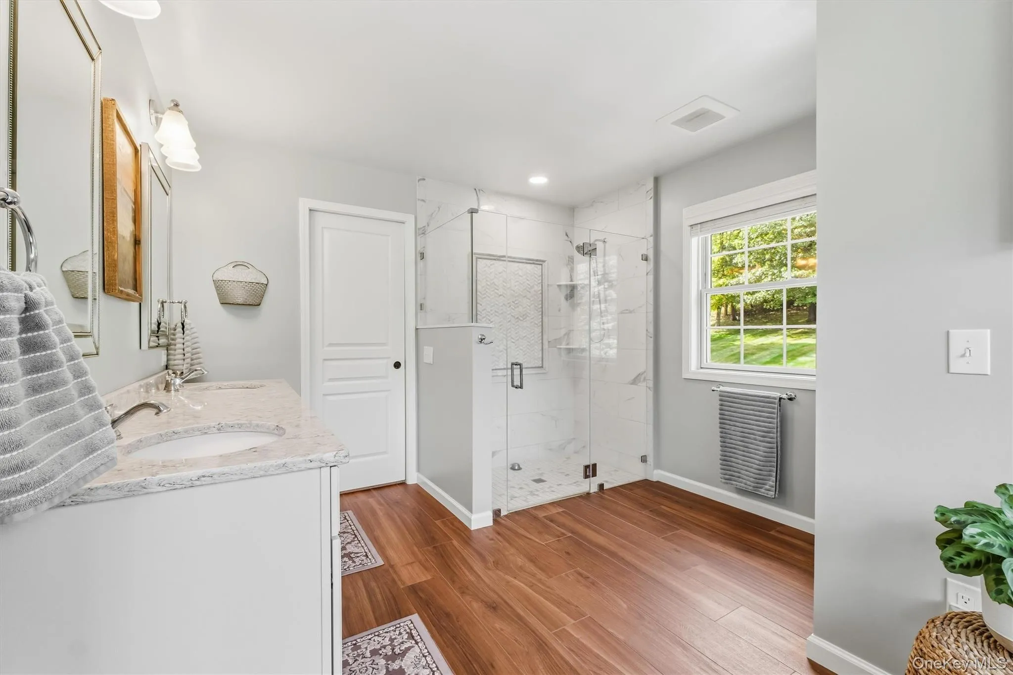 Step into your own private oasis in this newly redone, fully customized primary bath, where every detail has been designed to elevate everyday relaxation. The thoughtfully reimagined layout showcases an expansive custom walk-in shower finished with oversized tile, a convenient handheld sprayer, and a sleek frameless glass enclosure. An elegant soaking tub is perfectly positioned beneath a pair of windows that frame tranquil mountain views, creating an idyllic place to relax and recharge. Open, refined, and spa-inspired, this luxurious retreat brings together exceptional craftsmanship, modern comfort, and a true sense of serenity Step into your own private oasis in this newly redone, fully customized primary bath, where every detail has been designed to elevate everyday relaxation. The thoughtfully reimagined layout showcases an expansive custom walk-in shower finished with oversized tile, a convenient handheld sprayer, and a sleek frameless glass enclosure. An elegant soaking tub is perfectly positioned beneath a pair of windows that frame tranquil mountain views, creating an idyllic place to relax and recharge. Open, refined, and spa-inspired, this luxurious retreat brings together exceptional craftsmanship, modern comfort, and a true sense of serenity