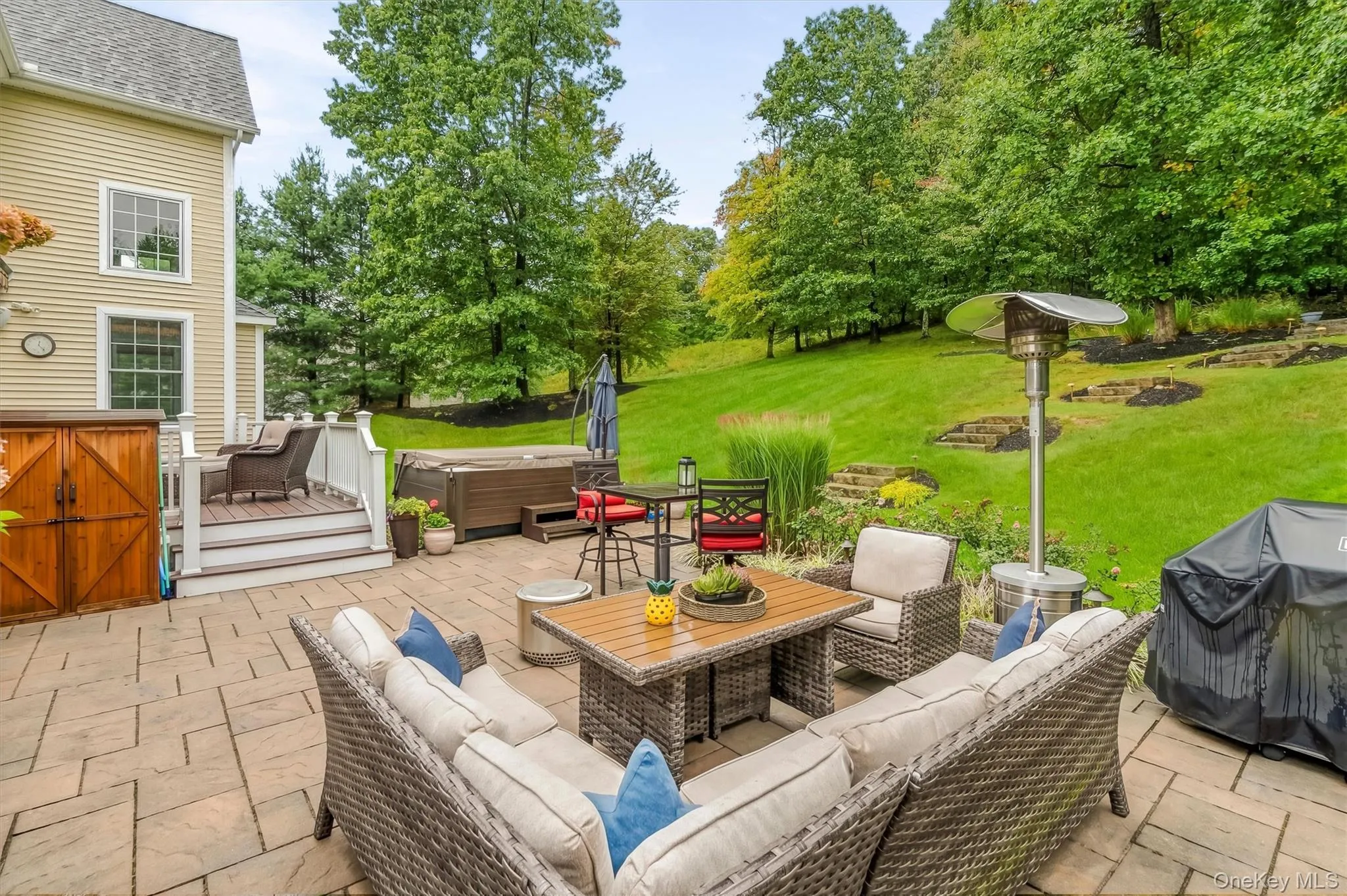 The lower patio is a true outdoor oasis, crafted with custom Unilock pavers and anchored by a stunning, oversized 8 person Hot Springs Spa installed in 2021 Its perfect for cozy evenings under the stars. There’s ample space for full-sized patio dining, a comfortable sitting area, and seamless access to the upper are via custom stone stepped staircase, thoughtfully designed to maximize usable patio & yard space. The lower patio is a true outdoor oasis, crafted with custom Unilock pavers and anchored by a stunning, oversized 8 person Hot Springs Spa installed in 2021 Its perfect for cozy evenings under the stars. There’s ample space for full-sized patio dining, a comfortable sitting area, and seamless access to the upper are via custom stone stepped staircase, thoughtfully designed to maximize usable patio & yard space.