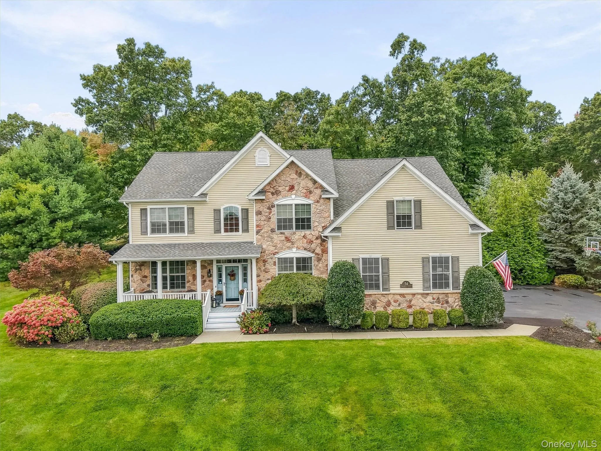 Stunning aerial view of this beautifully maintained home situated on manicured grounds with maximum privacy from mature trees and professional landscaping. The newly sealed driveway, with upgraded garage door, new garage door opener and keypad. A custom covered portico welcomes you into a spectacular, fully customized mudroom. Bluestone and paver walkways provide seamless access to both the front and rear yards, completing this exceptional property perfect for luxury living and entertaining. Stunning aerial view of this beautifully maintained home situated on manicured grounds with maximum privacy from mature trees and professional landscaping. The newly sealed driveway, with upgraded garage door, new garage door opener and keypad. A custom covered portico welcomes you into a spectacular, fully customized mudroom. Bluestone and paver walkways provide seamless access to both the front and rear yards, completing this exceptional property perfect for luxury living and entertaining.