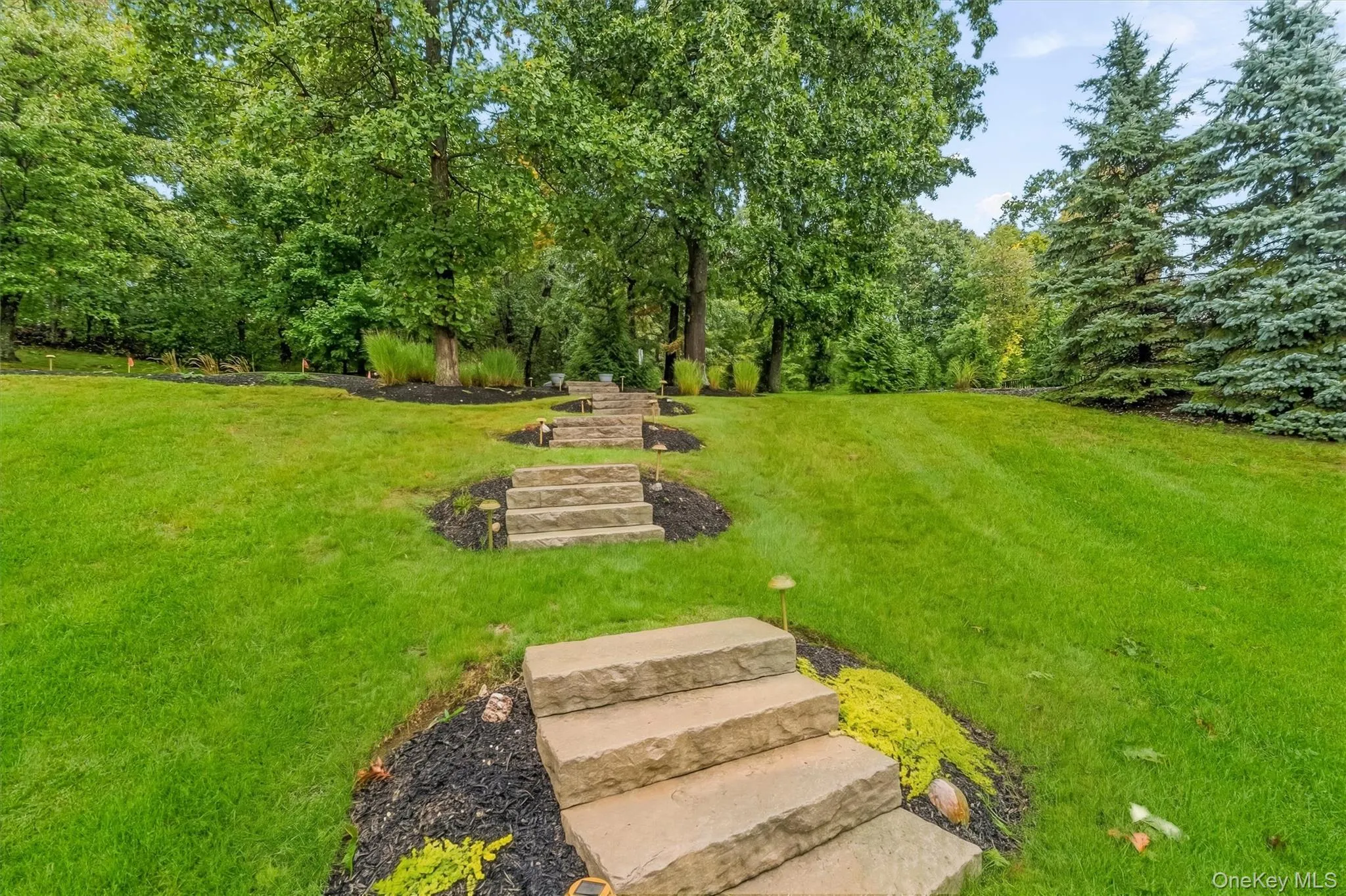 Thoughtfully designed across multiple tiers, this private backyard retreat blends beauty, recreation, and low-maintenance outdoor living. The custom Unilock patio creates a seamless connection between the home and its natural surroundings, offering an inviting setting for quiet mornings, lively gatherings, or relaxing evenings beside the firepit. Thoughtfully designed across multiple tiers, this private backyard retreat blends beauty, recreation, and low-maintenance outdoor living. The custom Unilock patio creates a seamless connection between the home and its natural surroundings, offering an inviting setting for quiet mornings, lively gatherings, or relaxing evenings beside the firepit.