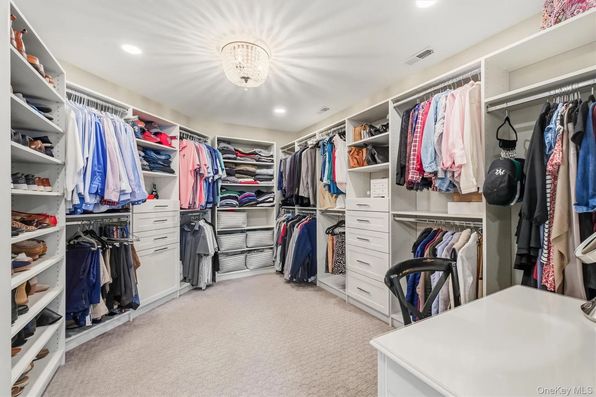view#1This MUST-HAVE CUSTOM DRESSING ROOM is More than a walk-in closet, this beautifully designed dressing room feels like a private boutique within the primary suite. Elegant pocket doors open to reveal custom cabinetry, built-in shelving, and thoughtfully planned storage for clothing, shoes, and accessories. An elegant chandelier adds a refined finishing touch, creating a bright and polished space where getting dressed feels effortless and enjoyable. Stylish, organized, and highly functional, this custom dressing room brings everyday luxury to your daily routine. view#1This MUST-HAVE CUSTOM DRESSING ROOM is More than a walk-in closet, this beautifully designed dressing room feels like a private boutique within the primary suite. Elegant pocket doors open to reveal custom cabinetry, built-in shelving, and thoughtfully planned storage for clothing, shoes, and accessories. An elegant chandelier adds a refined finishing touch, creating a bright and polished space where getting dressed feels effortless and enjoyable. Stylish, organized, and highly functional, this custom dressing room brings everyday luxury to your daily routine.
