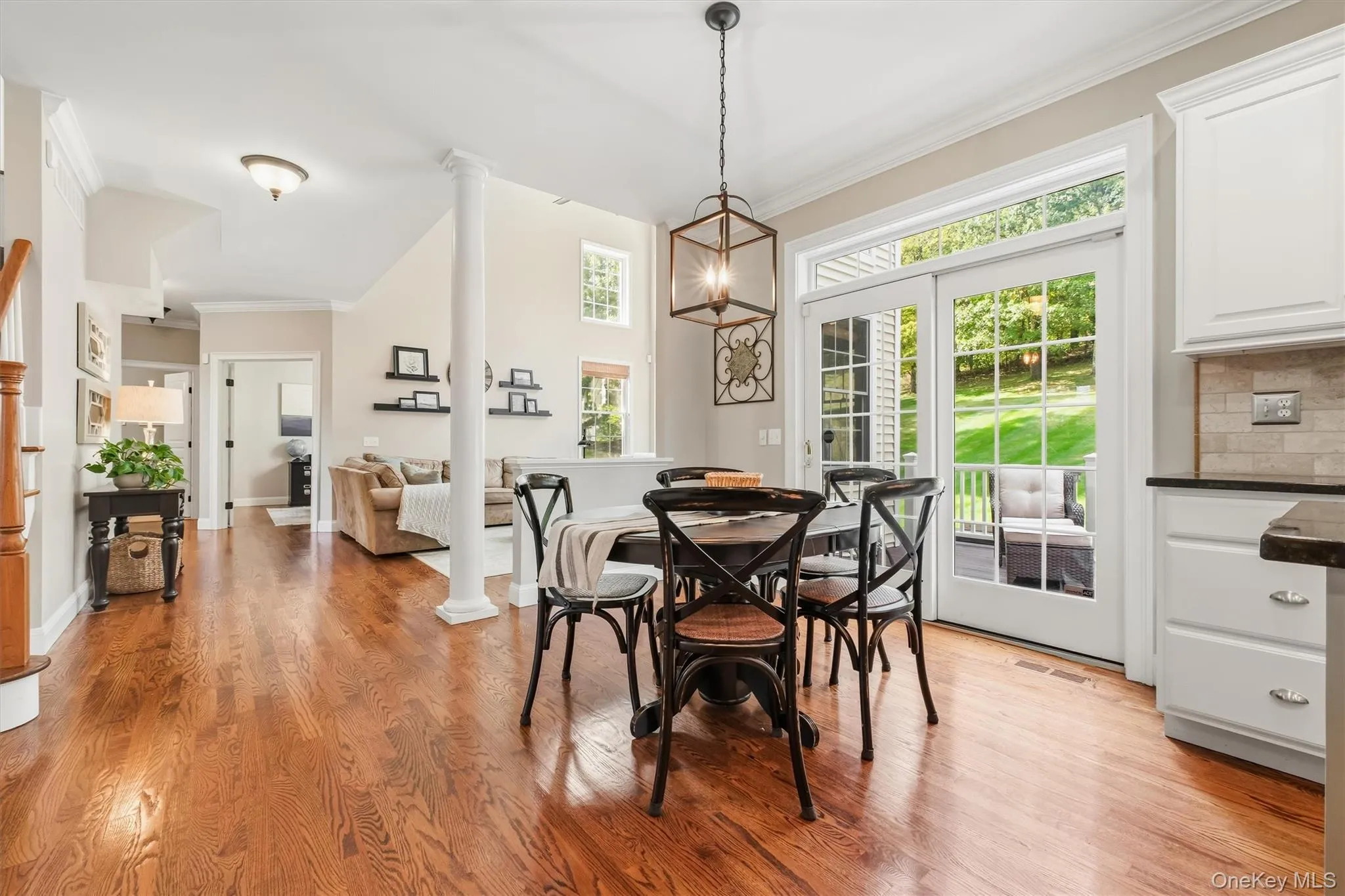 Enjoy breathtaking panoramic views from the eat-in area, where every meal feels like a retreat. A French-style wood sliding door frames views of the wooded rear lot and lush treetops, creating a serene backdrop throughout the year. Natural light pours into the space, highlighting the rich tones of the kitchen and enhancing the warm ambiance of the adjoining family room. The sliding door also provides seamless access to the Trex deck—perfect for indoor-outdoor entertaining or quiet mornings with a cup of coffee. Enjoy breathtaking panoramic views from the eat-in area, where every meal feels like a retreat. A French-style wood sliding door frames views of the wooded rear lot and lush treetops, creating a serene backdrop throughout the year. Natural light pours into the space, highlighting the rich tones of the kitchen and enhancing the warm ambiance of the adjoining family room. The sliding door also provides seamless access to the Trex deck—perfect for indoor-outdoor entertaining or quiet mornings with a cup of coffee.