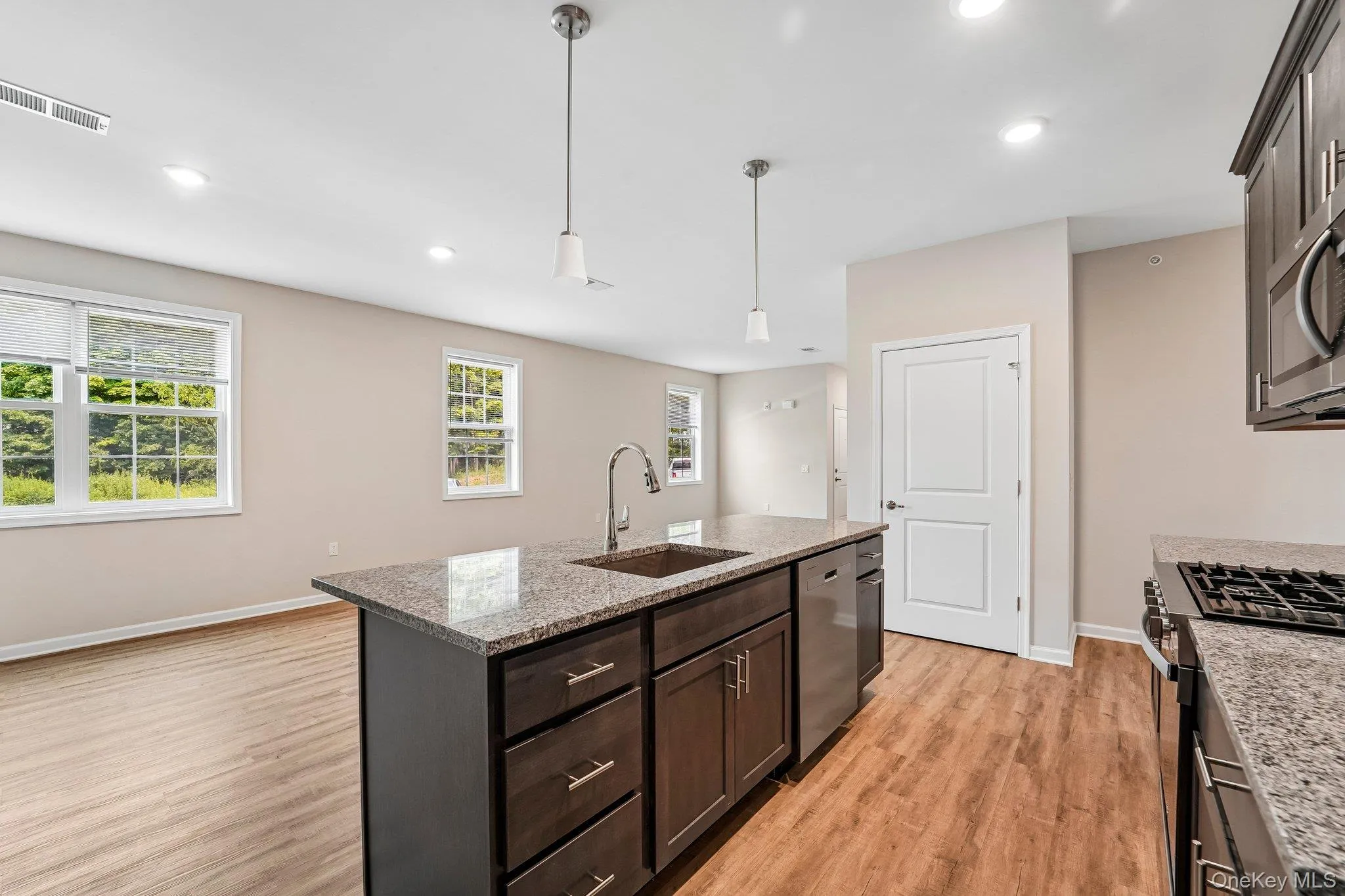 Kitchen island with a built-in sink and stainless steel appliances Kitchen island with a built-in sink and stainless steel appliances
