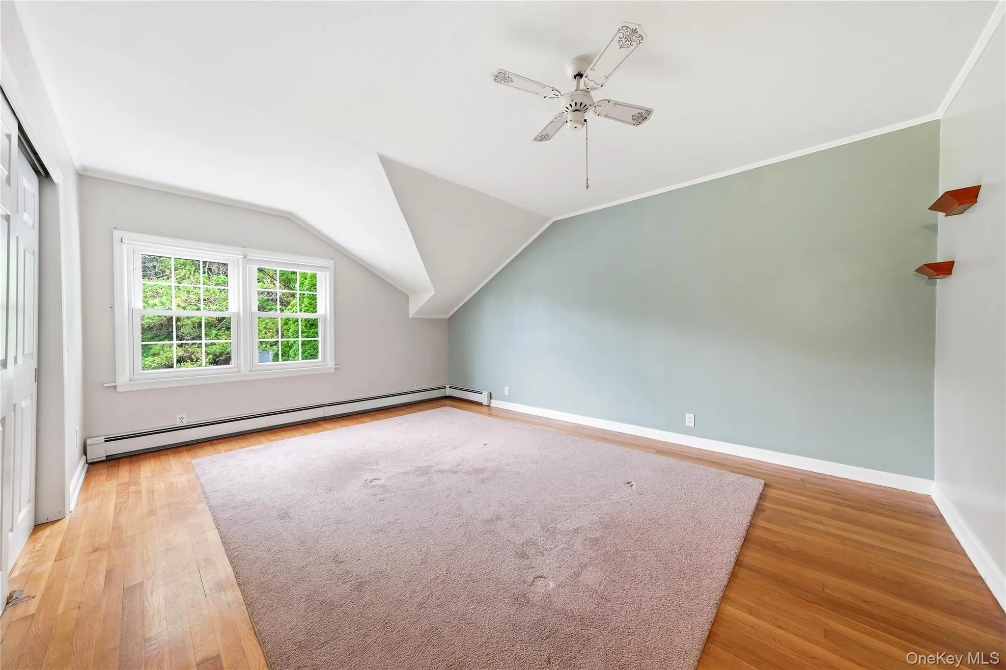 Generous sized bedroom with hardwood flooring and closet Generous sized bedroom with hardwood flooring and closet