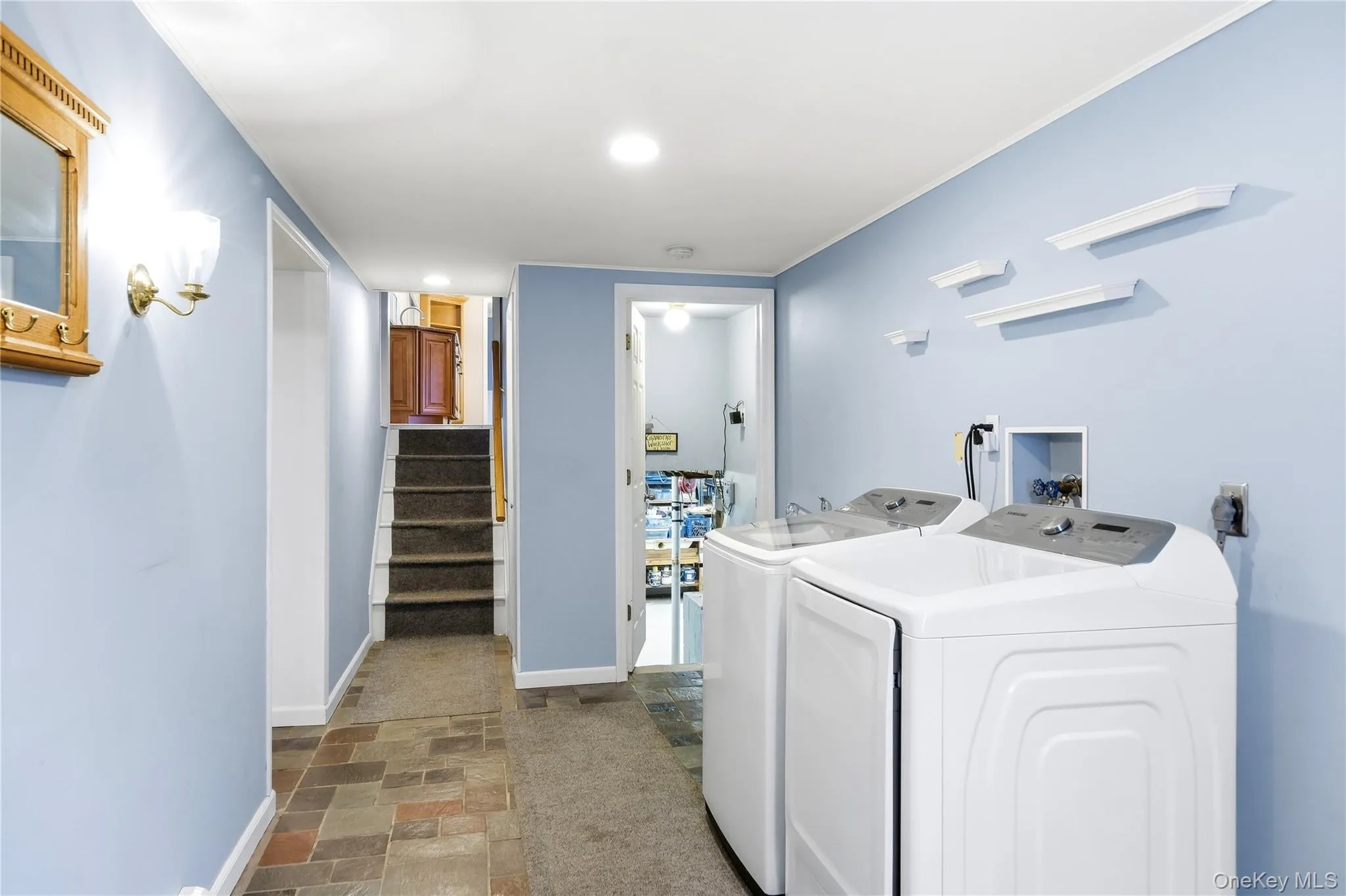 Laundry area featuring a utility sink connection, wall-mounted shelving, and recessed lighting Laundry area featuring a utility sink connection, wall-mounted shelving, and recessed lighting