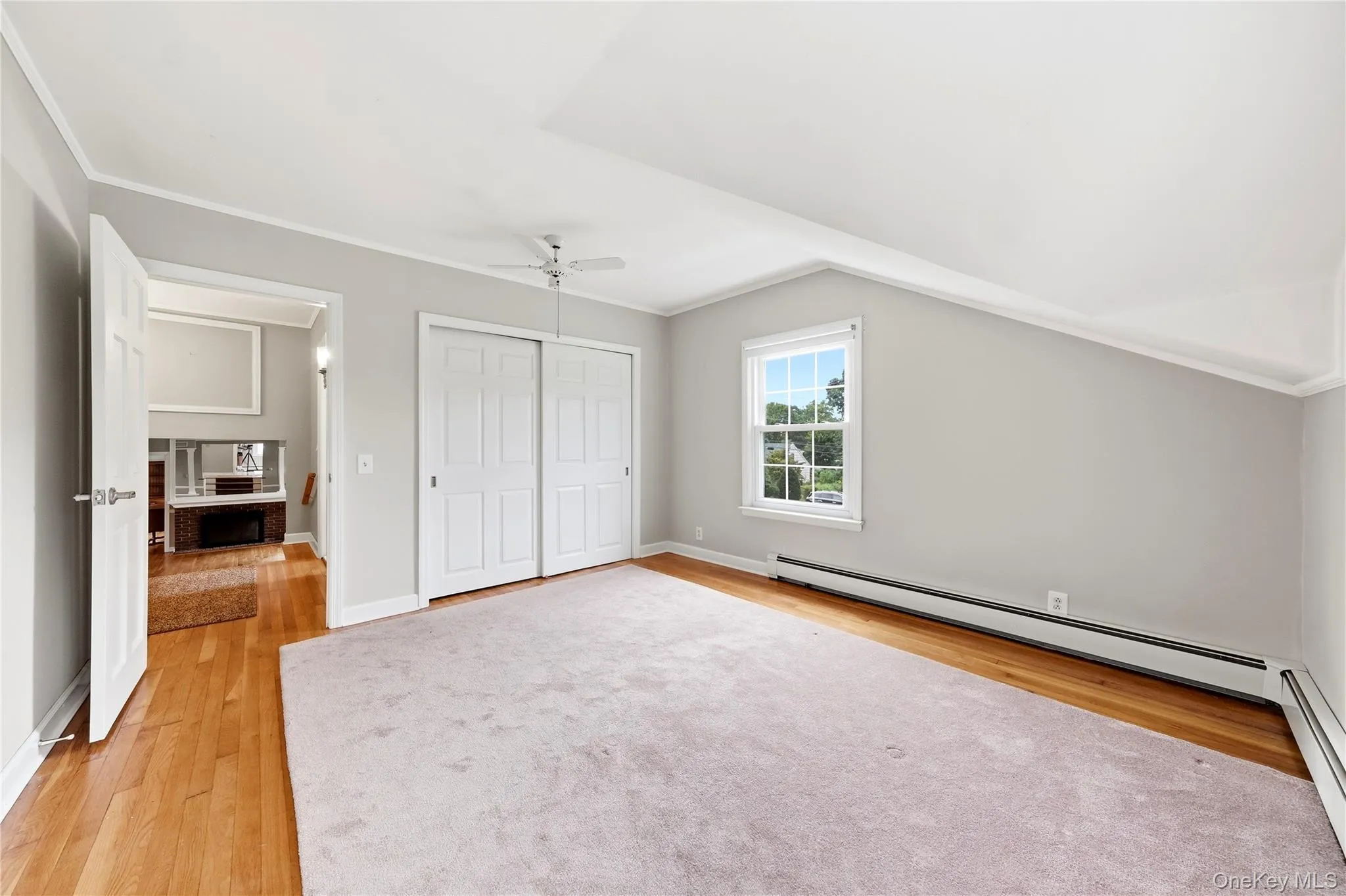 Generous sized bedroom with hardwood flooring and closet Generous sized bedroom with hardwood flooring and closet