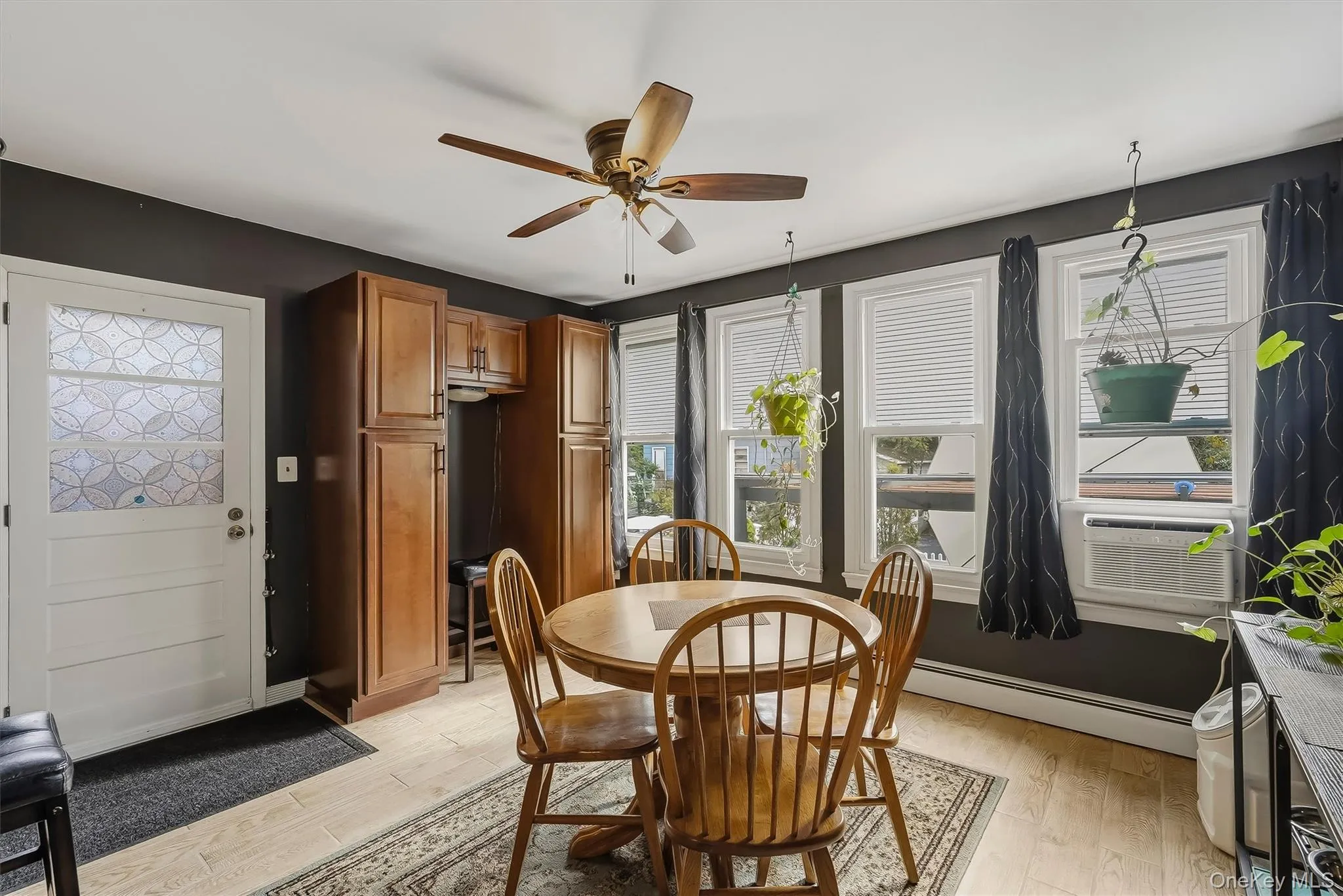 The spacious, sun filled dining area features additional storage space and a door to patio, parking and garage. The spacious, sun filled dining area features additional storage space and a door to patio, parking and garage.