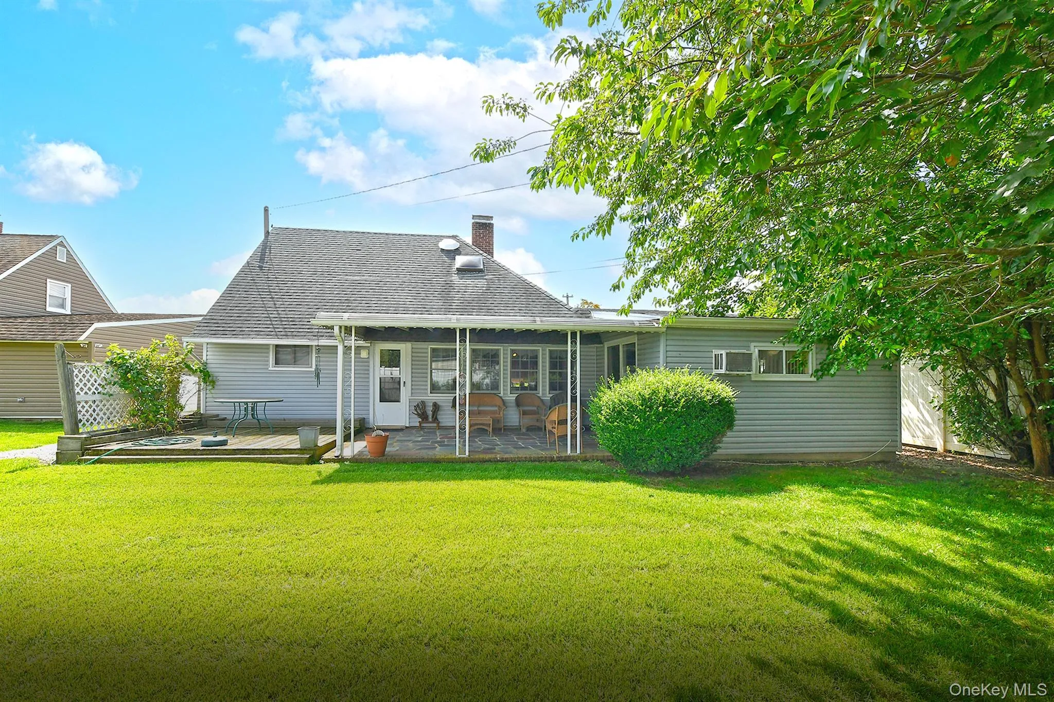 Expansive green lawn with mature perimeter foliage Expansive green lawn with mature perimeter foliage