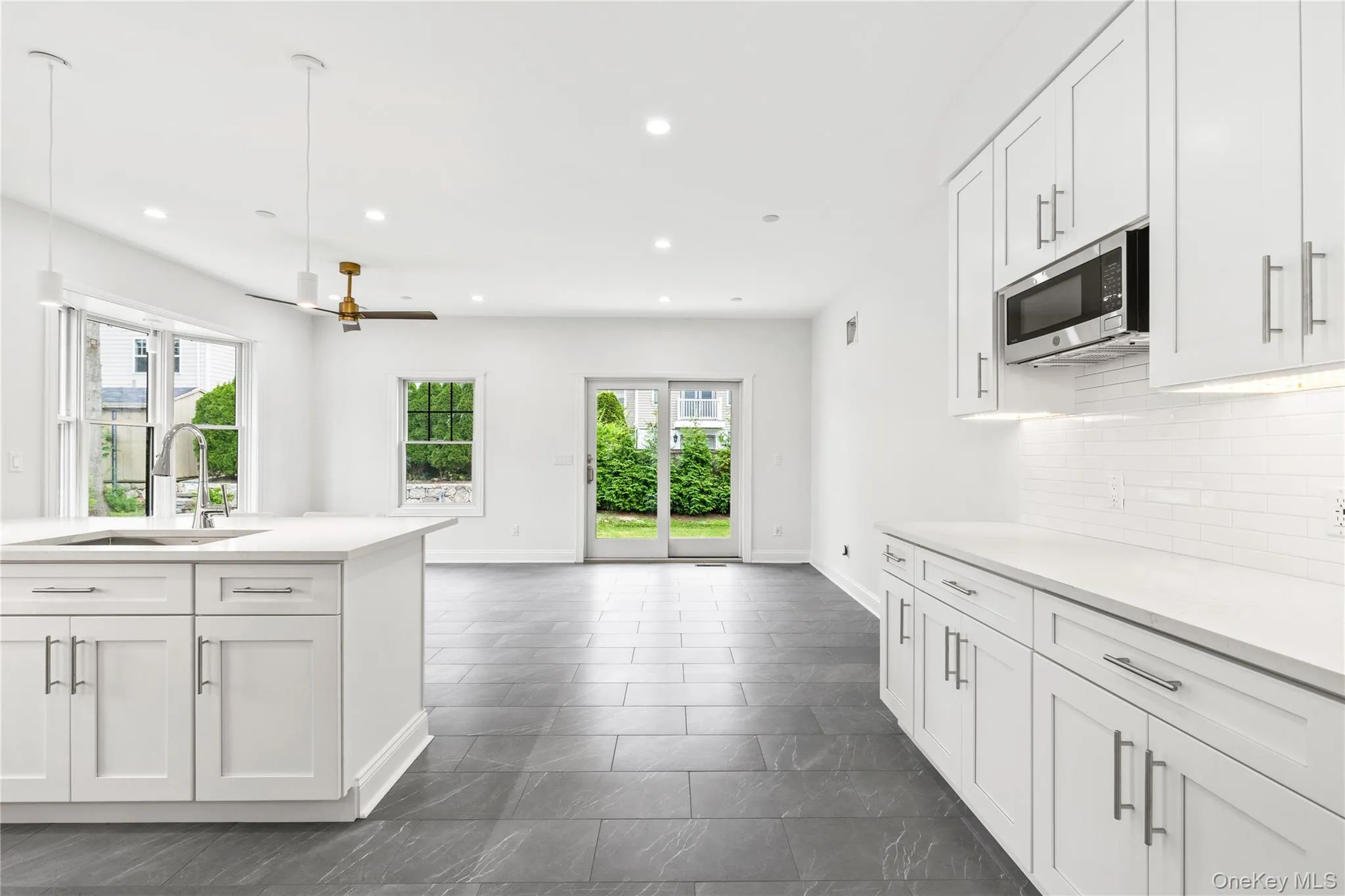 Sliding doors lead to the backyard where entertainment and play await. Sliding doors lead to the backyard where entertainment and play await.