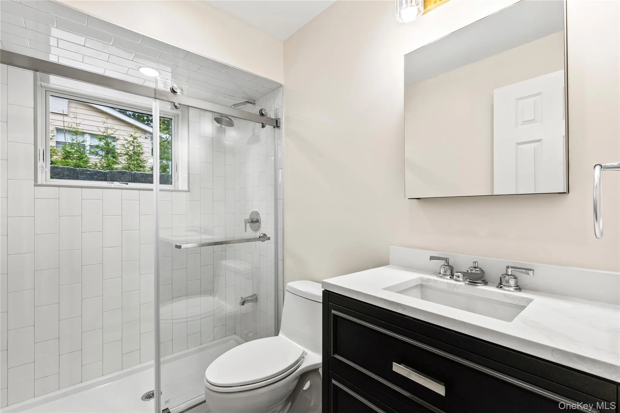 The Lower Level Bathroom enjoys natural light and stylish fixtures. The Lower Level Bathroom enjoys natural light and stylish fixtures.