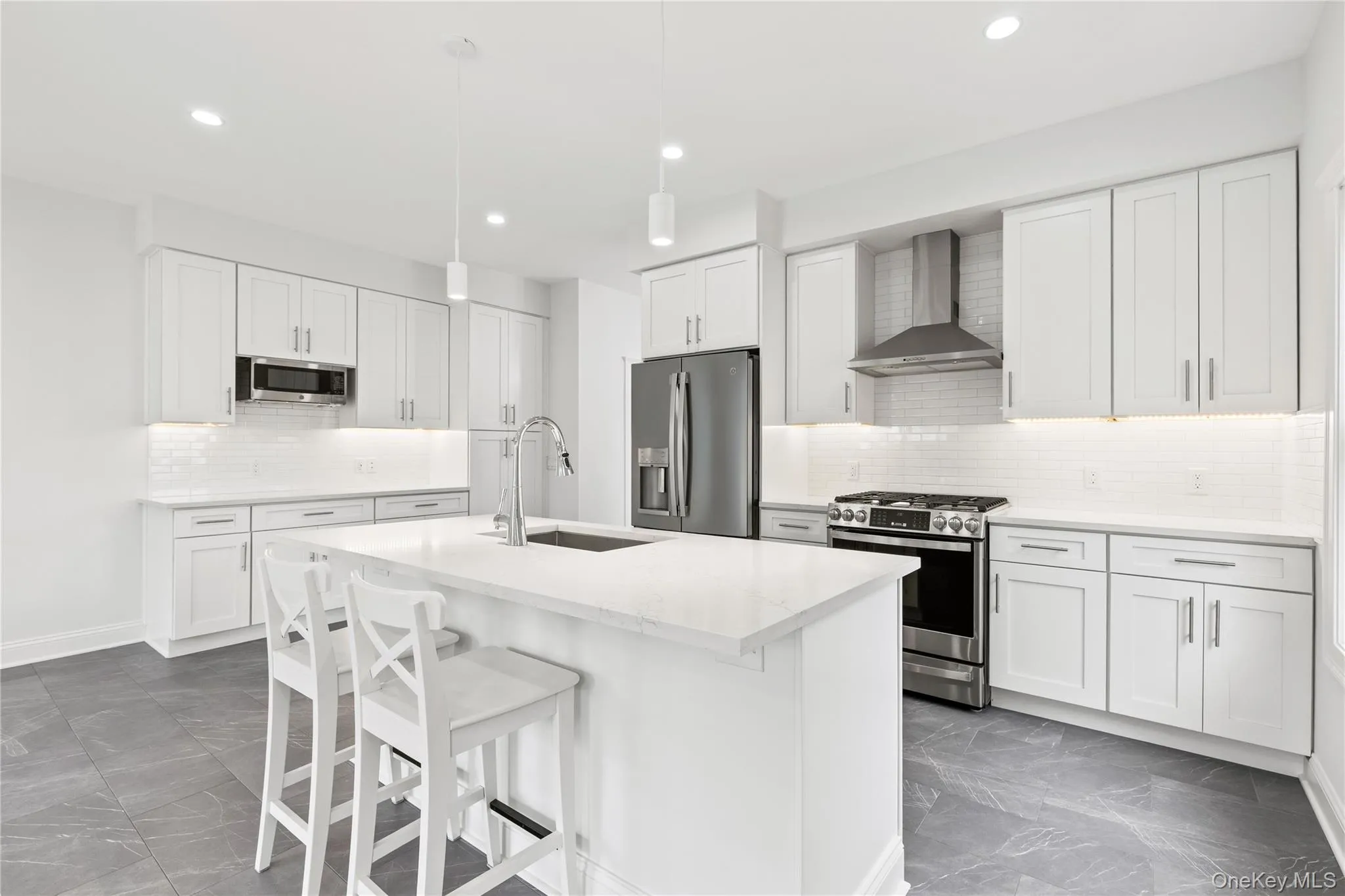 The delineating kitchen island offers at-the-counter seating for additional dining options. The delineating kitchen island offers at-the-counter seating for additional dining options.