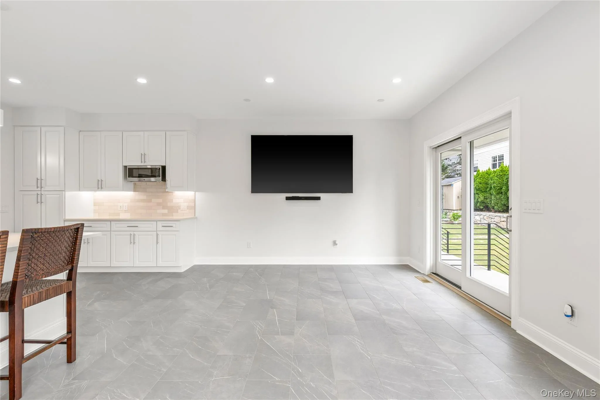 Sliding doors lead to the backyard where entertainment and play await. Sliding doors lead to the backyard where entertainment and play await.