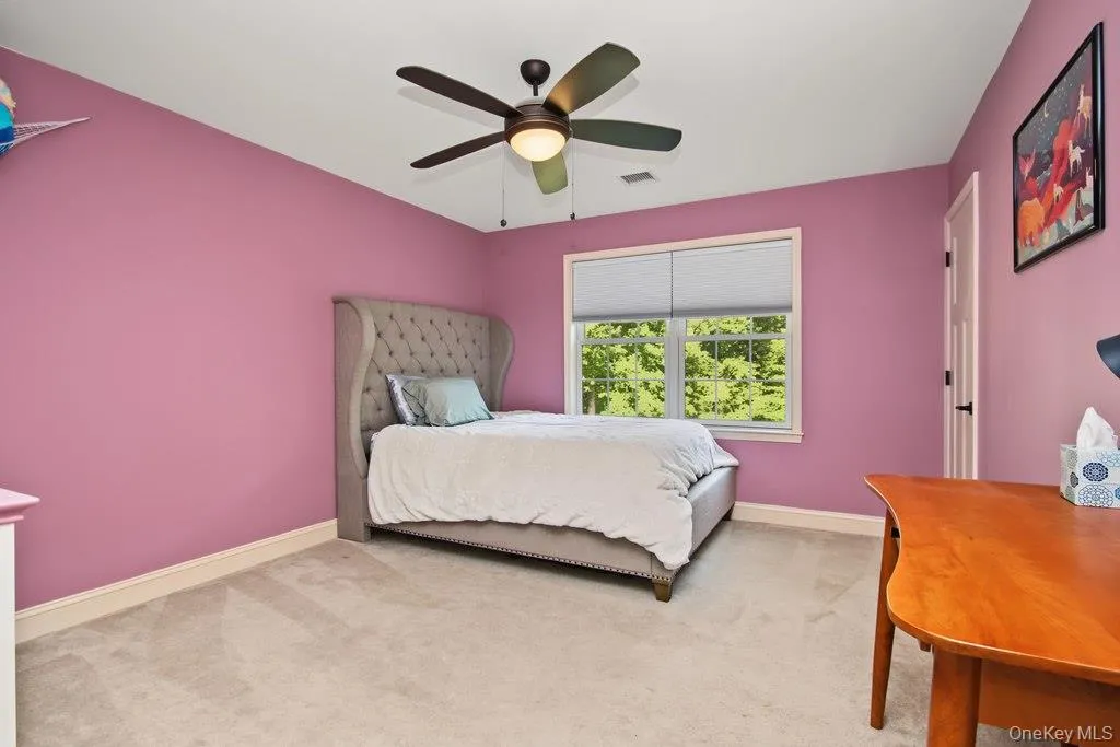 Window with roller shades, ceiling fan with integrated lighting, wall-to-wall carpeting Window with roller shades, ceiling fan with integrated lighting, wall-to-wall carpeting