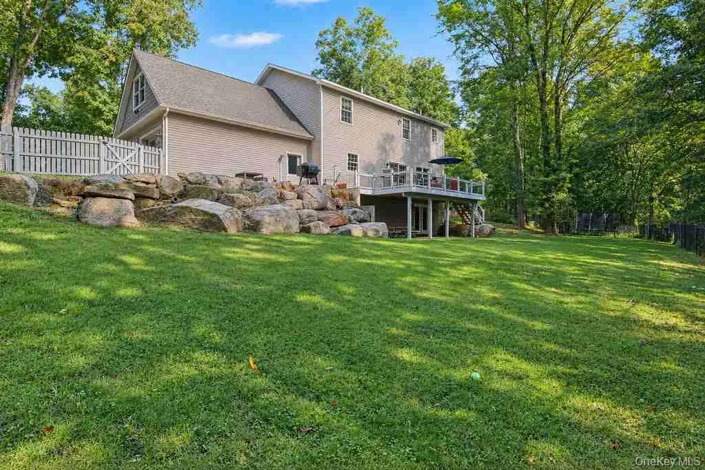 Expansive green lawn, multi-level decking, natural rock landscaping. Expansive green lawn, multi-level decking, natural rock landscaping.