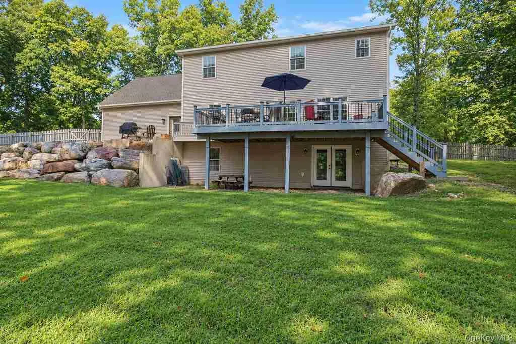 Raised rear deck and a large natural rock retaining wall Raised rear deck and a large natural rock retaining wall