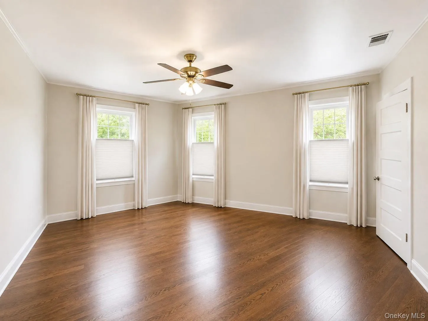 Primary bedroom with wood floors Primary bedroom with wood floors