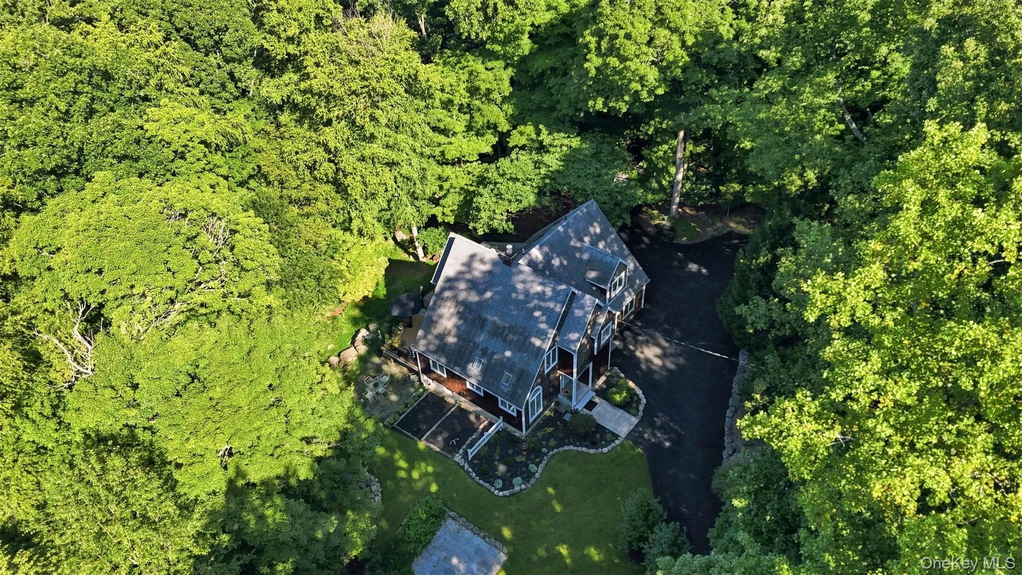 Aerial view of home surrounded by mature woods Aerial view of home surrounded by mature woods