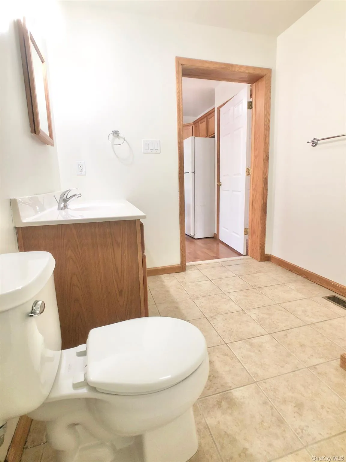 Half bath with vanity and light tile patterned flooring Half bath with vanity and light tile patterned flooring