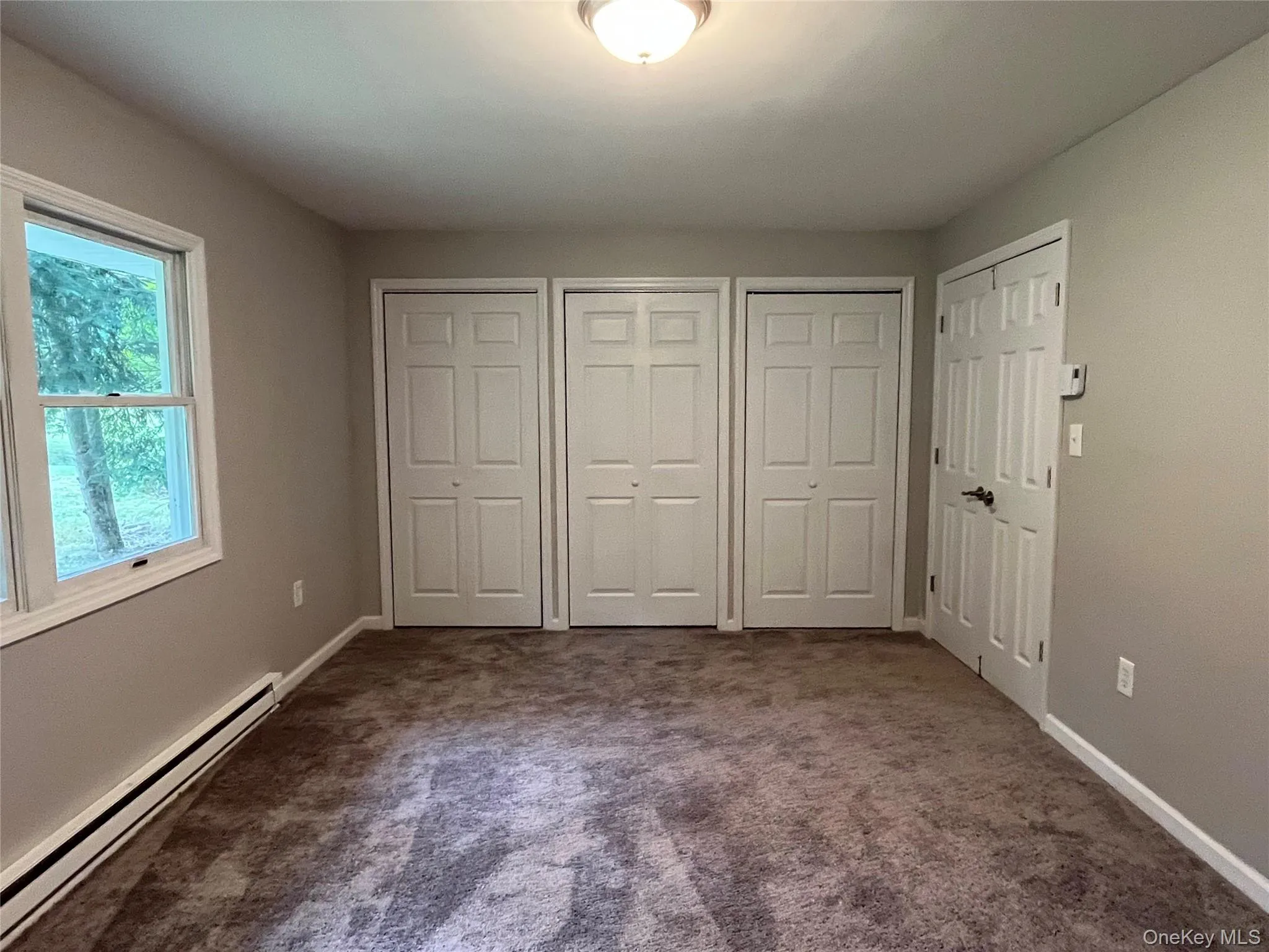 Plush carpeting, neutral wall palette, multiple bi-fold closet doors, and white trim Plush carpeting, neutral wall palette, multiple bi-fold closet doors, and white trim
