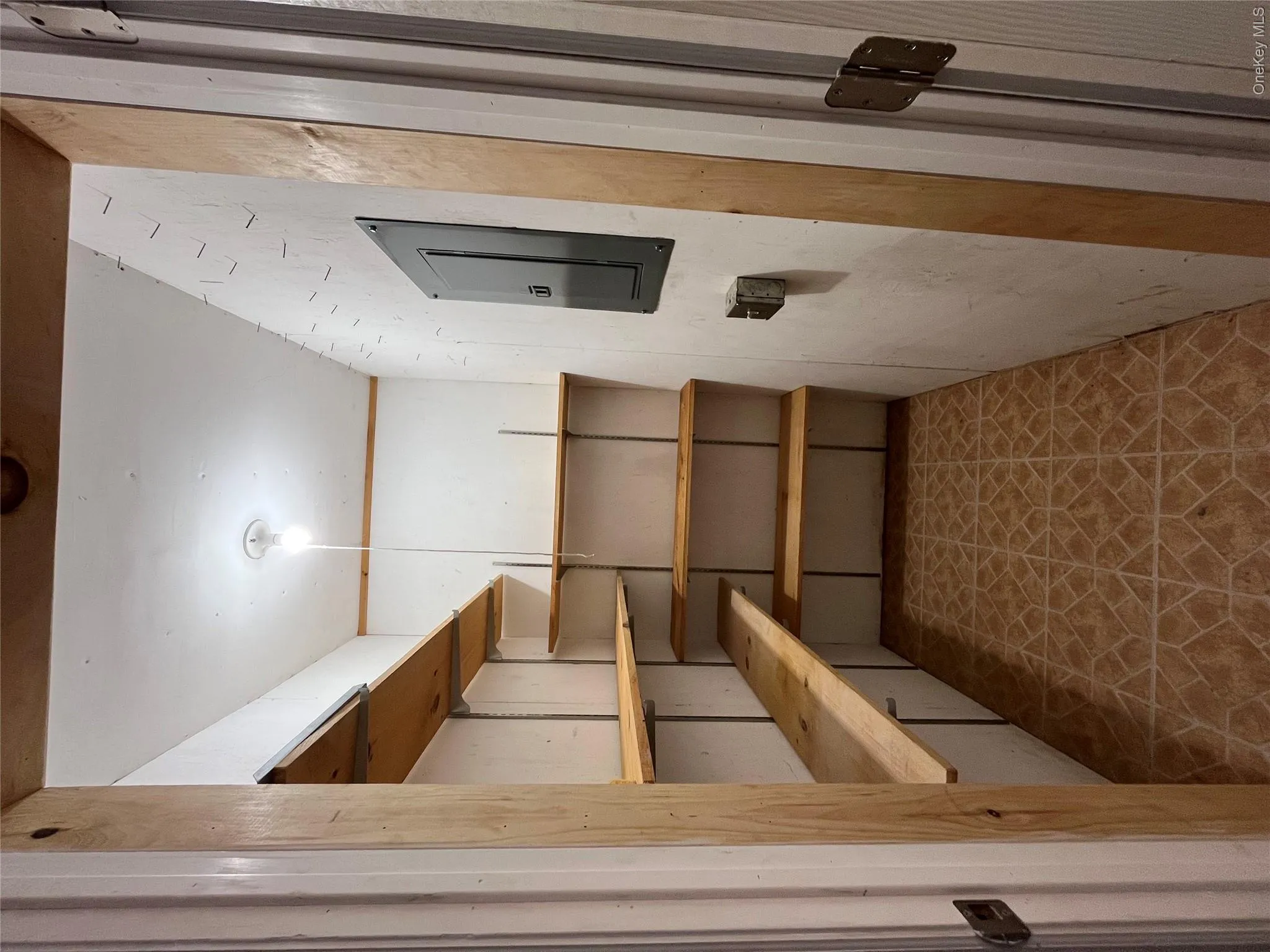 Custom wooden shelving system with multiple tiers and open storage throughout Custom wooden shelving system with multiple tiers and open storage throughout